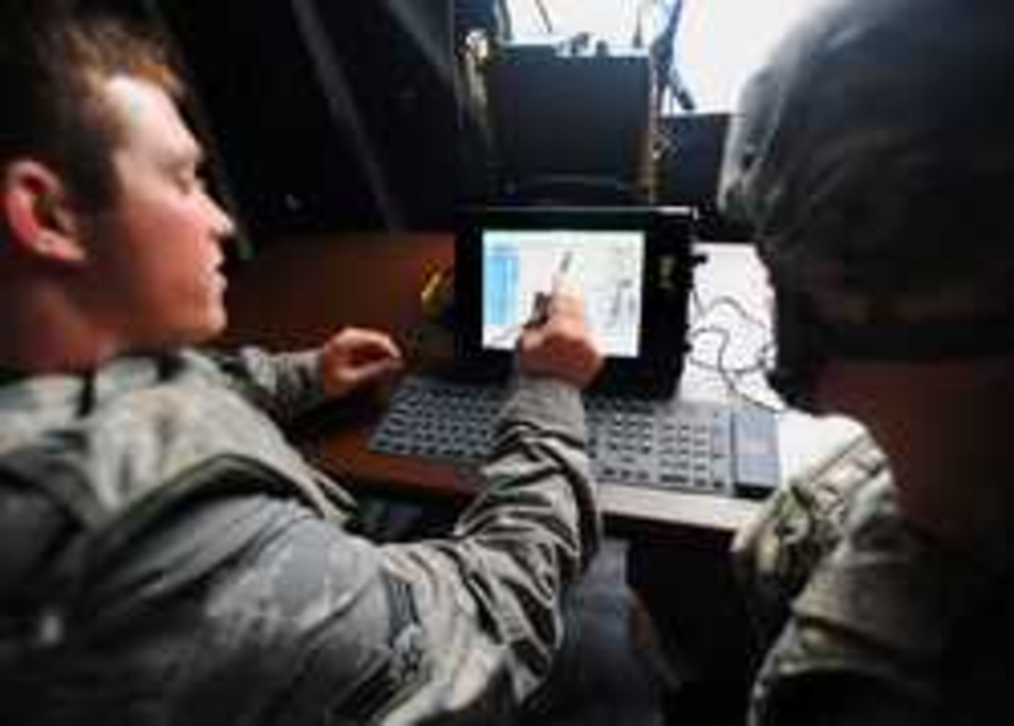 Senior Airmen Donald McKee, left, and Adam Croy learn how to use a Military Ruggedized Tablet Sept. 17 outside the McChord Field WADS facility during Pacific Strike - a joint training exercise with Airmen from 1st ASOG and WADS and Soldiers from I Corps’ Air Defense and Airspace Management Cell. (Courtesy Photo/Ingrid Barrentine)

