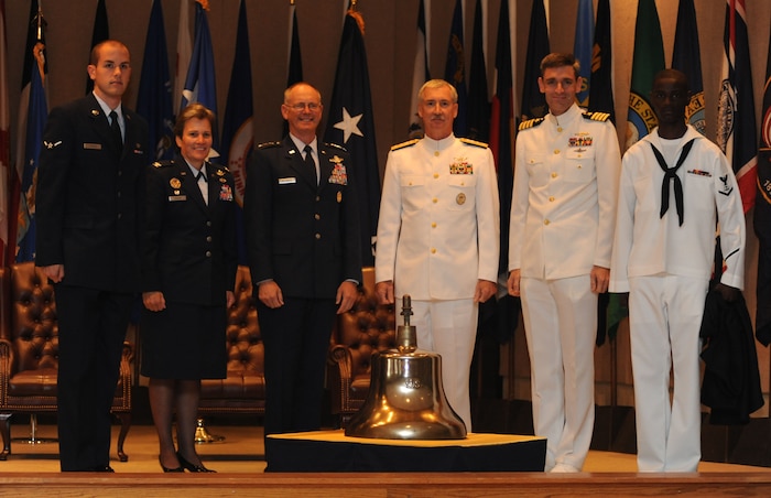 The official party of the Joint Base Charleston inaugural ceremony is joined by two of JB CHS's most junior service members during the unveiling of a retired Navy ship's bell that was presented in honor of the full operational capability of JB CHS Oct. 1, 2010. From the Navy?s earliest days, bells have been used for signaling, keeping time and sounding alarms. Their functional and traditional ceremonial uses have made them a symbol of considerable significance to the United States Navy. The bell presented originally served aboard the USS Moosbrugger, a Spruance Class destroyer homeported in Charleston between 1978 and 1995. (U.S. Air Force photo/Airman 1st Class Lauren Main)
