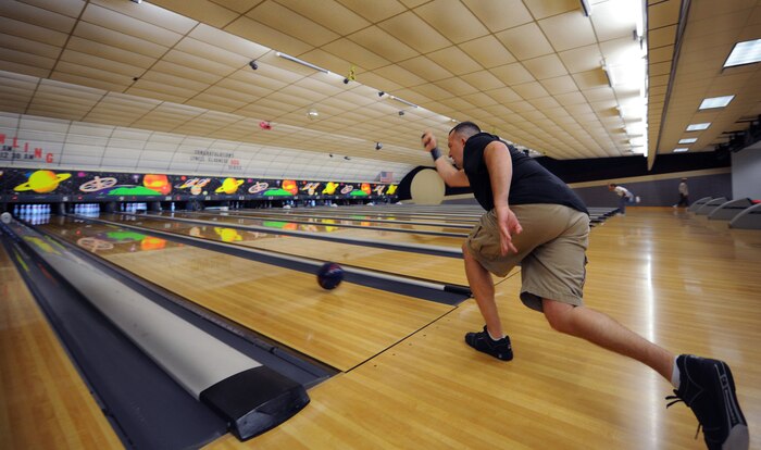Air Force Master Sgt. Pete Scheidt takes careful aim as he throws thebowling ball down his lane during a competition for the Commander's Cup at Marrington Lanes on Joint Base Charleston - Weapons Station Sept. 28, 2010. The Commander's Cup competition began Sept. 17 and was open to all Department of Defense employees and Joint Base Charleston members. The team with the most points from all events was then awarded the Commander's Cup during the JB CHS inaugural celebration Oct. 1, 2010. Sergeant Scheidt is a loadmaster with the 14th Airlift Squadron. (U.S. Air Force Photo/Airman 1st Class Lauren Main)