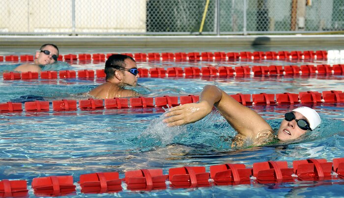 Navy Lt. j.g. Cassandra Mitchell races to the finish line during the two-man relay swim challenge held during the weeklong Commander?s Cup that led up to the full operational capability inauguration of Joint Base Charleston, S.C., Oct. 1, 2010. Lieutenant Mitchell is with the Naval Nuclear Power Training Center on Joint Base Charleston - Weapons Station. (U.S. Navy photo/Mass Communication Specialist 1st Class Jennifer R. Hudson/released)