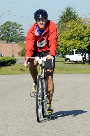 Air Force 2nd Lt. Ben Bressler finishes the bike race challenge in record time on Joint Base Charleston, S.C., taking first place during the Commander?s Cup on the joint base's inaugural day Oct. 1, 2010. A weeklong series of challenges included golf, volleyball, basketball, a run and swim were held in celebration of the inauguration of Joint Base Charleston. Lieutenant Bressler is attached to the 628th Civil Engineer Squadron. (U.S. Navy photo/Mass Communication Specialist 1st Class Jennifer R. Hudson/released)