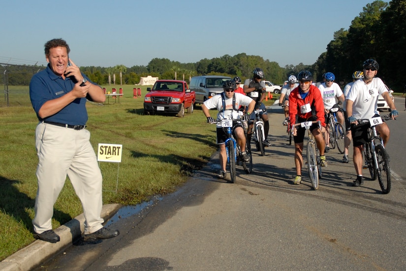 Joint Base Charleston?s Fitness and Sports Center Director Steve Parrish prepares to give the starting signal to send JB CHS Commander?s Cup bicycle competitors to the Weapons Station. Participants competed in a ride from the Air Base to the Weapons Station in celebration of Joint Base Charleston reaching full operational capability as the two bases merged Oct. 1, under Defense Department realignment. (U.S. Air Force photo/Eric Sesit)