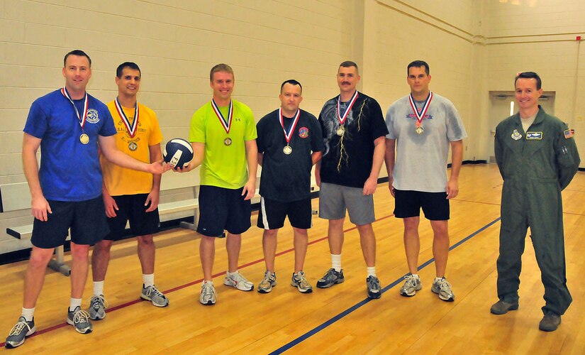 Air Force members of the 14th Airlift Squadron join for a final snapshot after winning the Commander's Cup volleyball challenge at the Fitness and Sports Center on Joint Base Charleston, S.C., Sept. 30, 2010. The game was held between the 14 AS and the 628th Communications Squadron. The 14 AS won two consecutive matches, earning them the title in the best-out-of-three series. The members of the team were, from left to right, Maj. Adam Tufts, 1st Lt. Lucas Berreckman, Capt. Clayton White, Master Sgt. Pete Scheidt, Tech. Sgt. Kevin Owens, Master Sgt. Gary Kleinfeldt, who were joined by 14 AS Commaner Lt. Col. Randall Huiss. (U.S. Air Force photo/Staff Sgt. Daniel Bowles.)