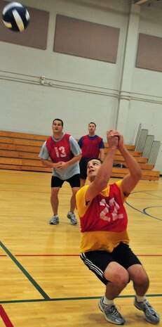 Air Force 1st Lt. Lucas Berreckman sets the ball for teammates on a serve return during the Commander's Cup volleyball challenge at the Fitness and Sports Center on Joint Base Charleston, S.C., Sept. 30, 2010. The game was part of a weeklong series of sporting events leading up to JB CHS's full operating capability inauguration. Sporting events preceding the volleyball challenge were golf, bowling and basketball, followed by bike, run and swim relay challenges held on the Oct. 1, 2010, inaugural day. Lieutenant Berreckman is with the 14th Airlift Squadron. (U.S. Air Force photo/Staff Sgt. Daniel Bowles.)