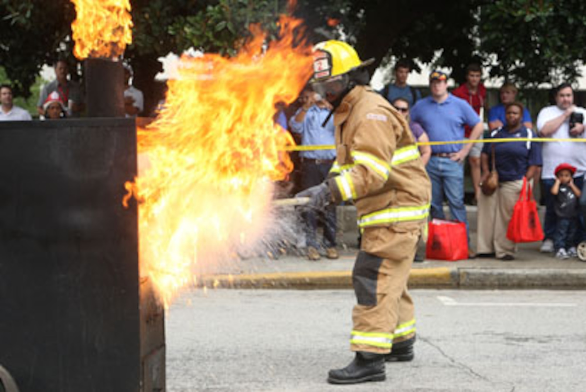 Firefighters from the Dobbins Fire Department demonstrate what happens when grease fires are not handled properly for a fire awareness carnival crowd Sep. 30. (U.S. Air Force Photo/Don Peek)