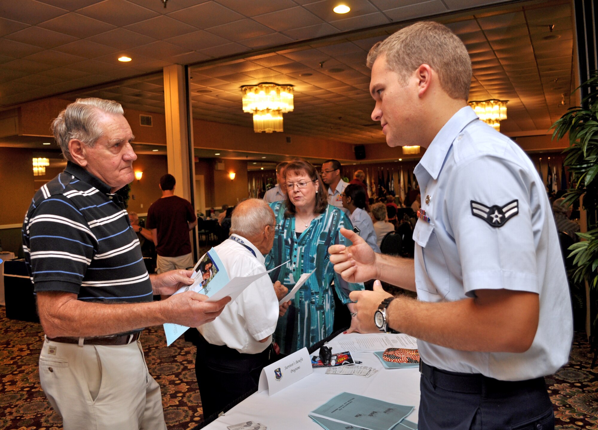 Airman 1st Class Samuel Nabakowski, 14th Operations Support Squadron and a volunteer at this year’s Retiree Appreciation Day, gives information on the Airman and Family Readiness Center to Retired Tech. Sgt. William Eubanks Sept. 24 at the Columbus Club. (U.S. Air Force photo/Staff Sgt. Jacob Corbin). 