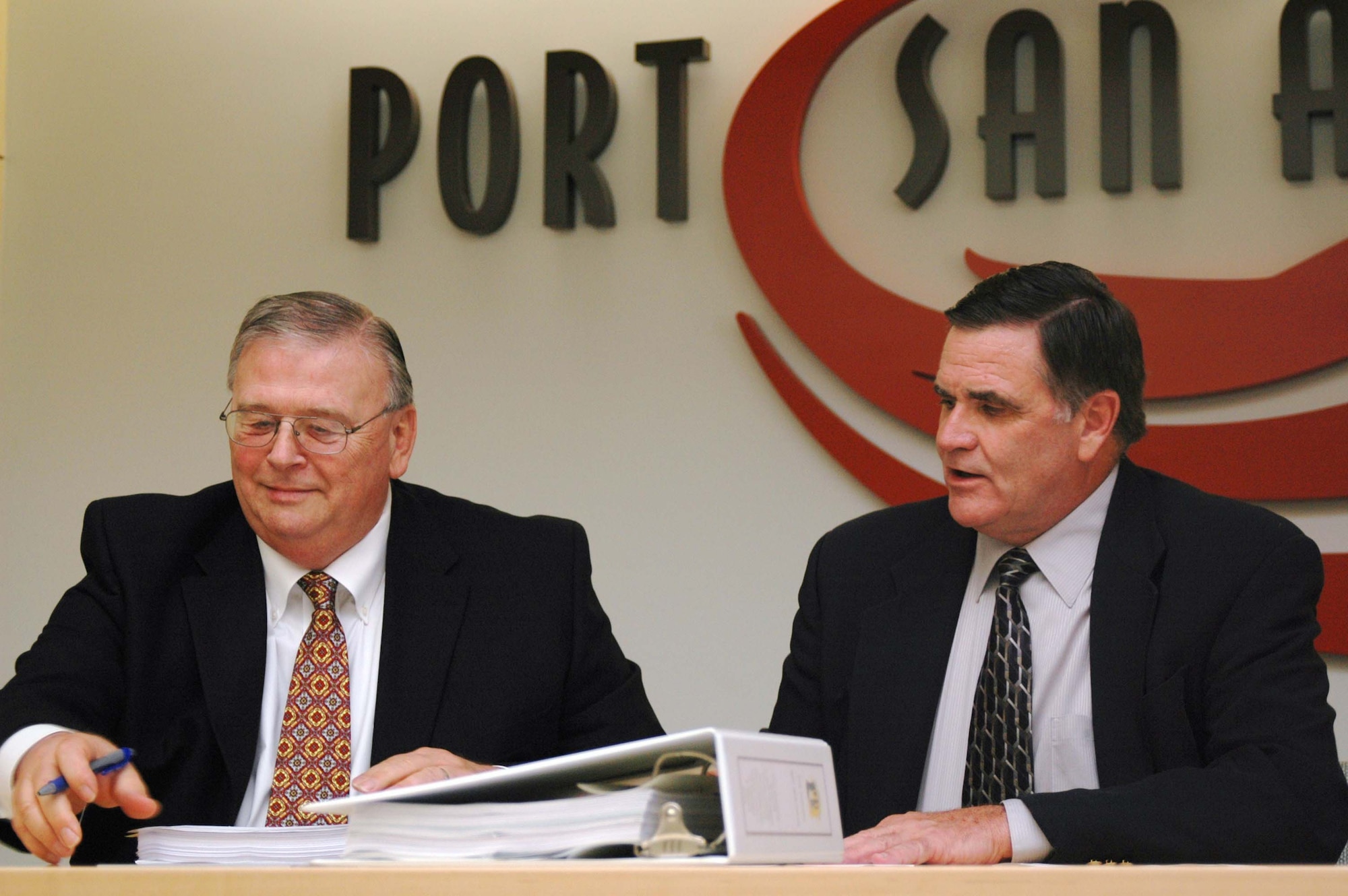 Mr. Bob Moore, AFRPA Director, and Mr. Bruce Miller, President and CEO of Port San Antonio, sign the deed to transfer the remaining 389 acres of the former Kelly Air Force Base to the Port of San Antonio.
