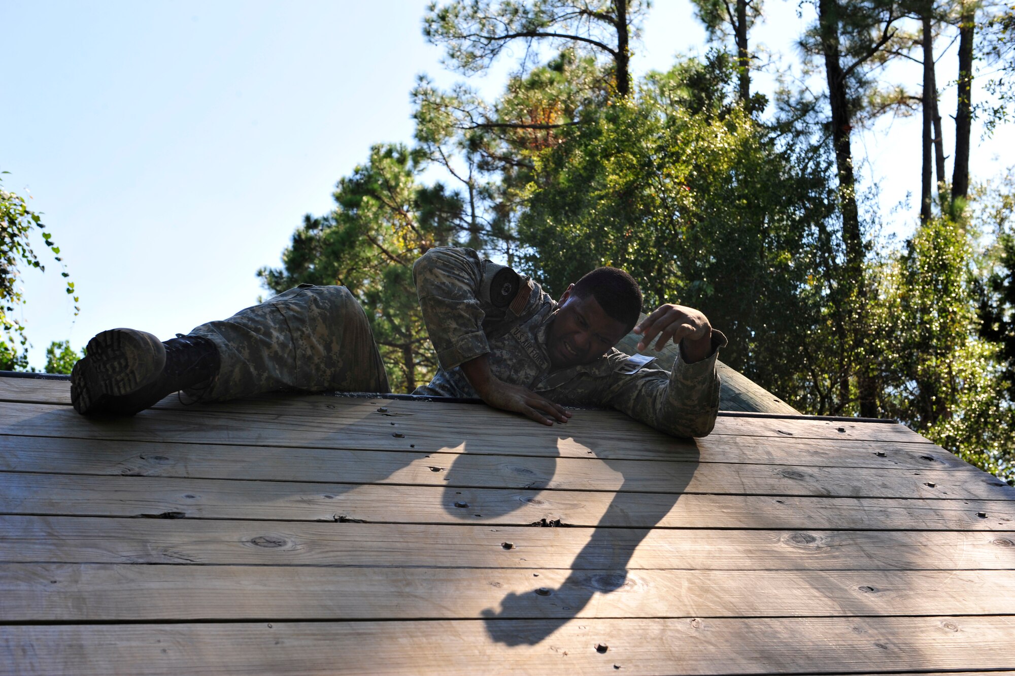Jalen Rose, an ESPN/NBA analyst, climbs up a wall obstacle in ?The Jungle,? the Tactical Air Control Party (TACP) training course at Hurlburt Field Fla., Sept. 29, 2010. ESPN along with many other media oulets are visiting Hurlburt Field to document the Miami HEAT?s training camp that?s taking place at the Aderholt Fitness Center from Sept. 28 through Oct. 3, 2010. (DoD Photo by Staff Sgt. Stephanie Jacobs/RELEASED)
