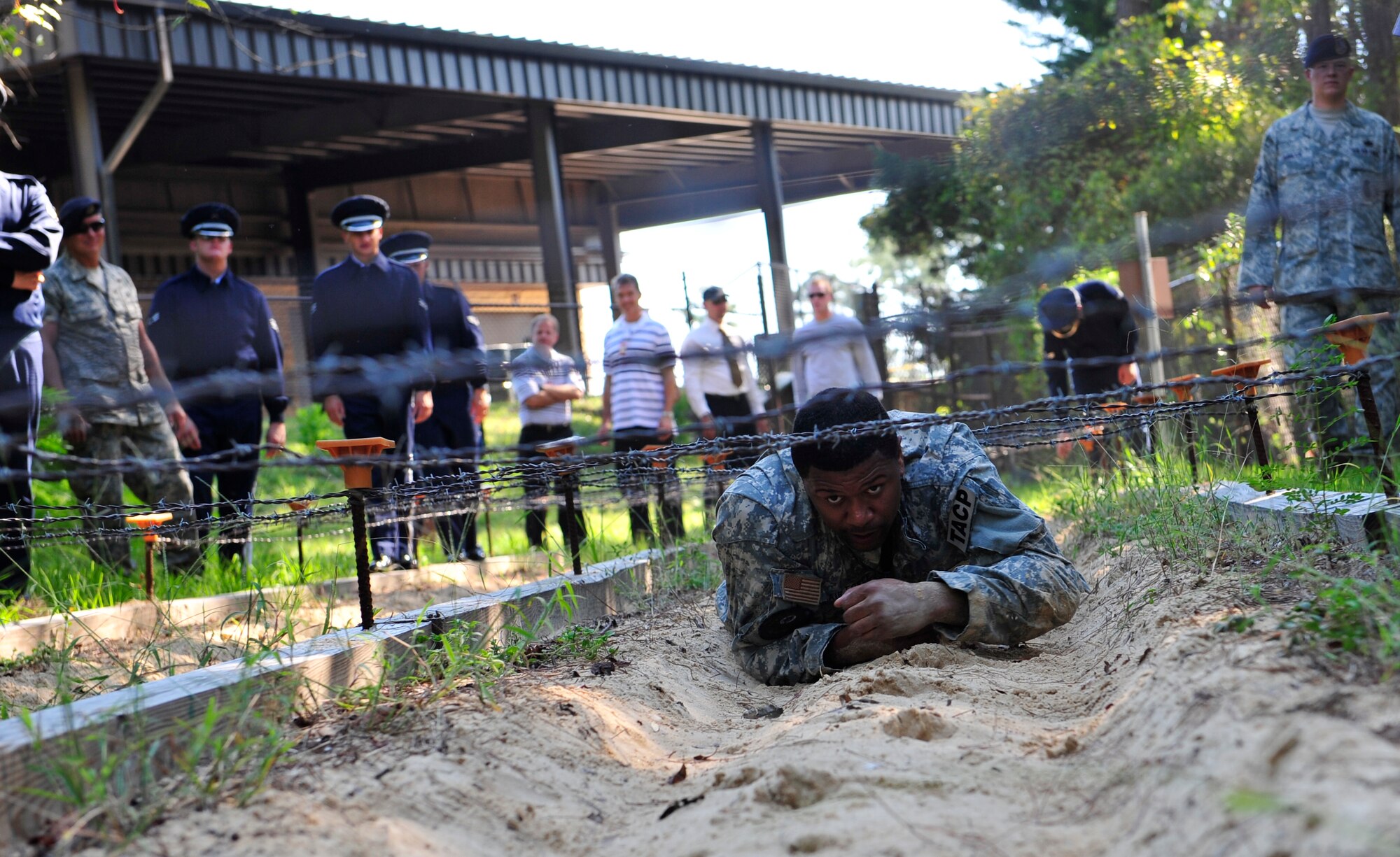 Jalen Rose, an ESPN basketball analyst, low-crawls during an obstacle course hosted by the Tactical Air Control Party instructors at Hurlburt Field, Fla., Wednesday, Sept. 29, 2010. (U.S. Air Force photo by Staff Sgt. Stephanie Jacobs) (Released) 