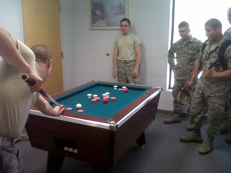 BARKSDALE AIR FORCE BASE, La. -- Airmen take turns playing bumper pool at the River's Edge. The River's Edge offers a wide range of activities such as video game tournaments, a music room with various instruments, food and drinks, free wireless Internet and more. The River's Edge is held from 6-10 p.m. Tuesdays and Thursdays and from 6 p.m. to midnight on Fridays. (Courtesy Photo)