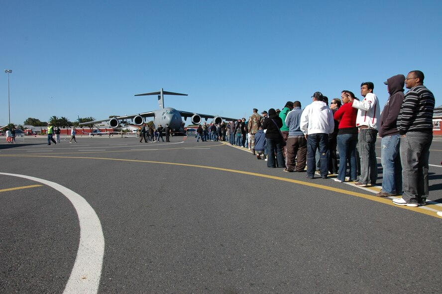 Patrons line up for the C-17 Globemaster III static display at the Africa Aerospace and Defense Expo, Sept. 25 at Ysterplaat Air Force Base Cape Town, South Africa. A Reserve aircrew from the 317th Airlift Squadron Charleston Air Force Base, South Carolina introduced the C-17 to thousands of visitors over the five day trade and air show.