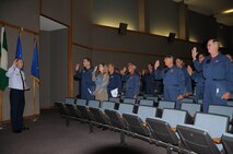 LAUGHLIN AIR FORCE BASE, Texas – Col. Michael Frankel, 47th Flying Training Wing commander, swears in Laughlin’s 84 flight simulator instructors as government employees at Anderson Hall here Oct. 1. The sim instructors, who were formerly contractors, became government employees after the start of the new fiscal year. (U.S. Air Force photo by Airman 1st Class Blake Mize) 