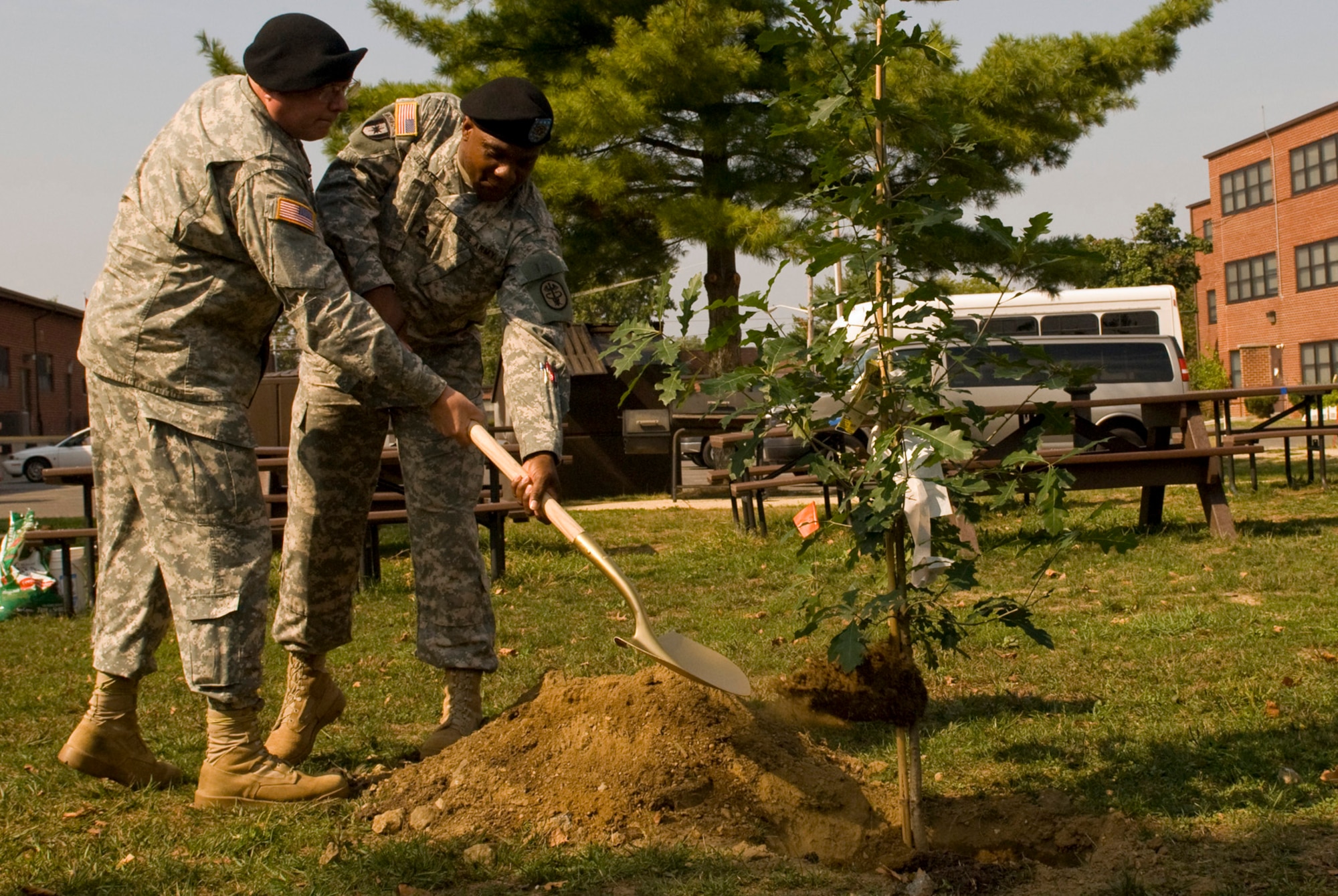 Col. Mark Wilhite and Master Sgt. Steve Jeffrey of Walson Medical Support Element, shovel the first scoop of dirt onto the ceremonial oak trees planted during this year’s observance of suicide prevention month Sept. 24 at JB MDL. (U.S. Army photo/Staff Sgt Andrew Guffey)