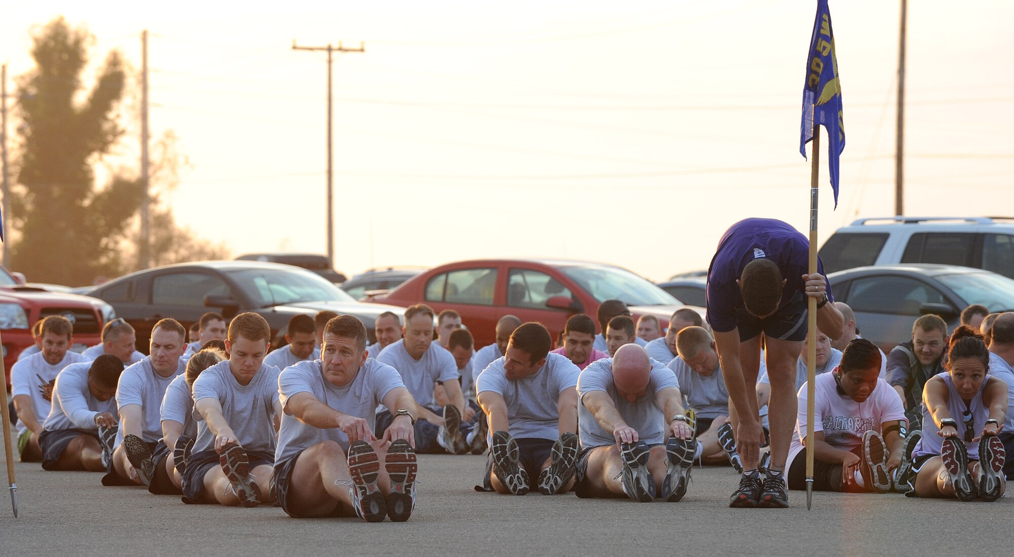 VANDENBERG AIR FORCE BASE, Calif. -- Lt. Col. Charles Vogt, the 30th Operations Support Squadron commander, stretches out with members of his squadron before taking part in the Fit-to-Fight Run here Thursday, Sept. 30, 2010. Airmen from the 30th Space Wing and the base's tenant units run together every month to ensure Airmen maintain a high standard of physical fitness. (U.S. Air Force photo/Senior Airman Ashley Reed)