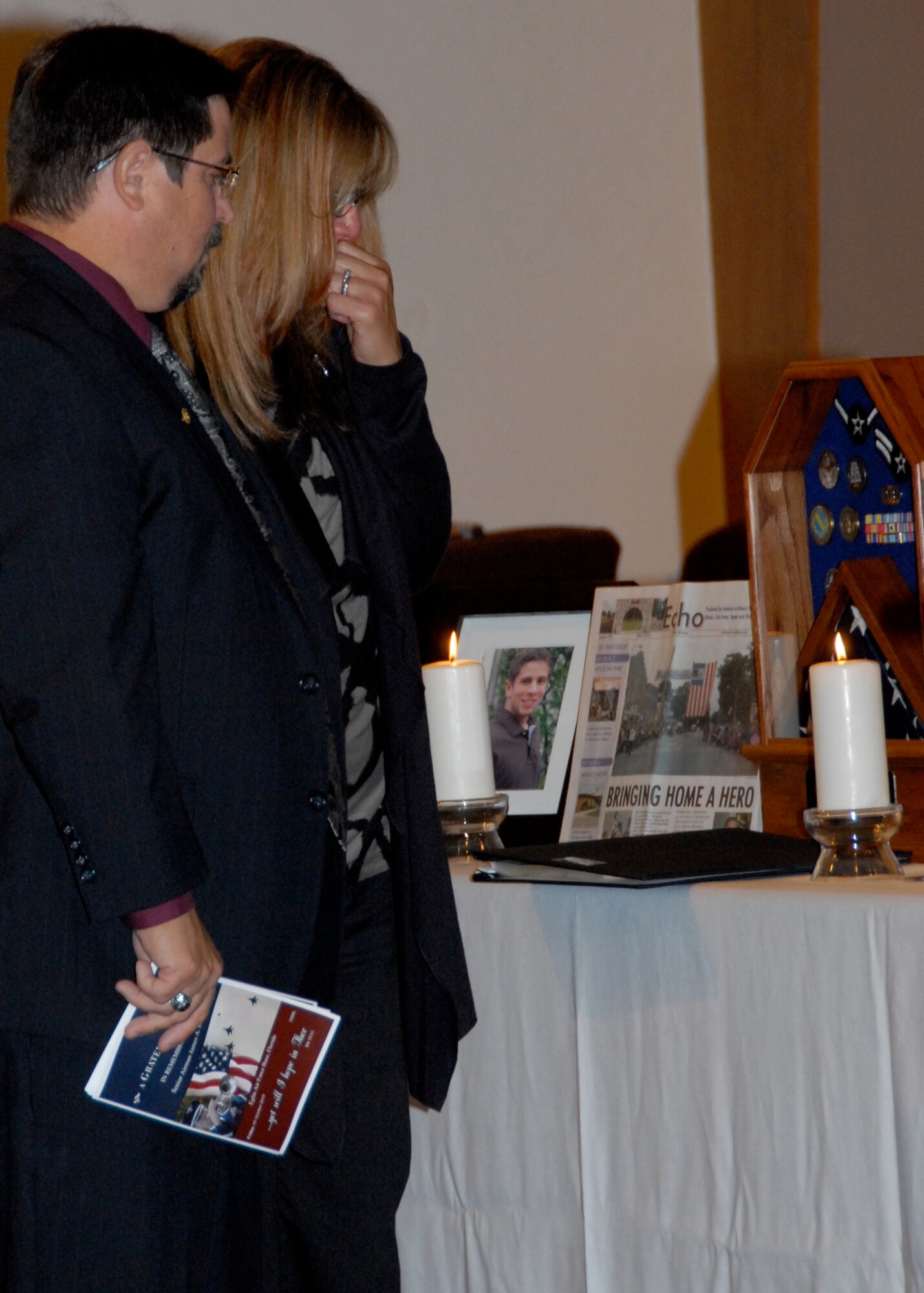 Dr. Rich and Emily Hansen mourn and honor their son, Senior Airman James Hansen, during Eglin's memorial ceremony Oct. 1 at the East Gate Chapel. The 46th Test Wing, Eglin senior leaders and the base community gathered  together to commemorate the life of the airfield management operations Airman who died Sept. 15 from injuries received during a controlled detonation at Joint Base Balad, Iraq.  (U.S. Air Force photo/Sachel Seabrook)