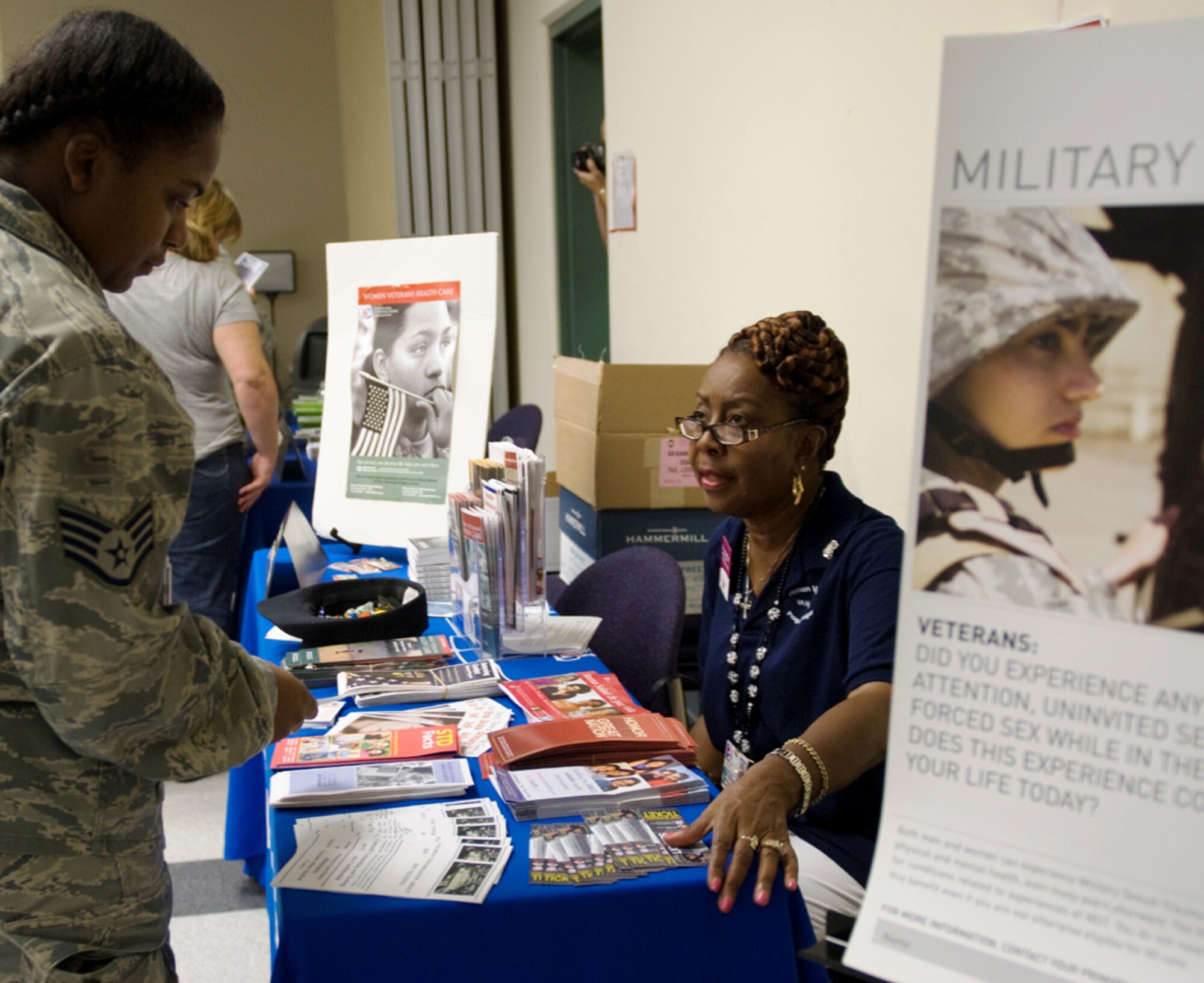 Gwendolyn Phillips, licensed clinical social worker, and Women’s Veteran’s Program Manager for the Department of Veterans Affairs Medical Center in Philadelphia, Pa., provides information on women’s benefits to Staff Sgt. Yvette Hackett, 514th, Mission Support Squadron, during a Women’s Health Fair Lunch n’ Learn here Sept. 25. (U.S. Army photo/Sgt. Carina M. Garcia)