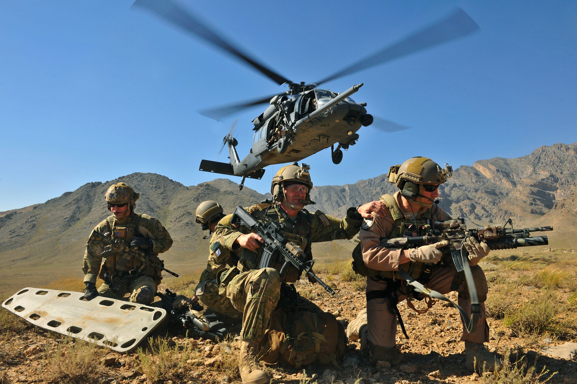 An HH-60G Pave Hawk hovers over pararescuemen and Brig. Gen. Jack L. Briggs, the 455th Air Expeditionary Wing commander, during a training mission at Bagram Airfield, Afghanistan, Sept. 24, 2010. The training mission provided a glimpse of what the 33rd Expeditionary Rescue Squadron brings to the fight and the capabilities it provides to combat commanders. (U.S. Air Force photo/Staff Sgt. Christopher Boitz)
