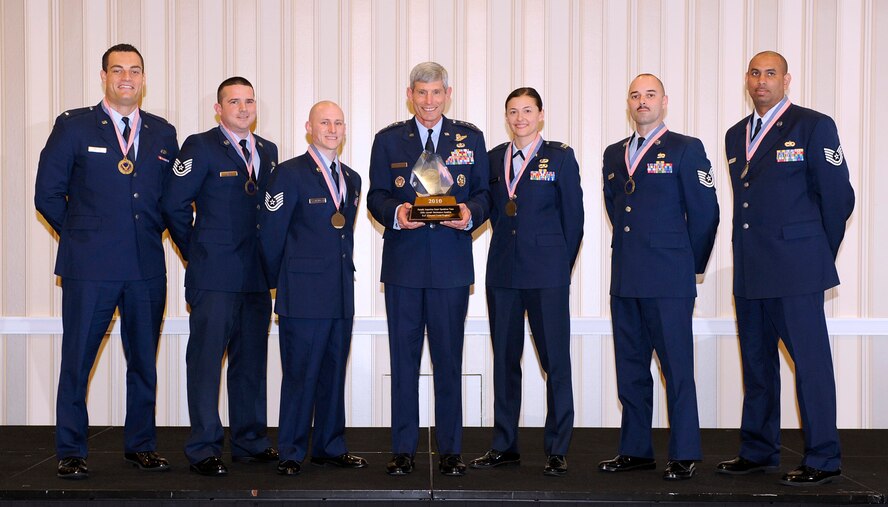 (From left to right) First Lieutenant Zachary Harris, Tech. Sgt. Ryan LaVere, Tech. Sgt. Christopher Klaus, Air Force Chief of Staff Norton Schwartz, Capt. Angelina Stephens, Tech. Sgt. Christopher Comeau and Tech. Sgt. William Brooks from teh 100th Maintenance Squadron's Periodic Inspection Smart Operations Team at Royal Air Force Mildenhall, United Kingdom, receive their Air Force CSAF Team Excellence Award. (Courtesy photo) 