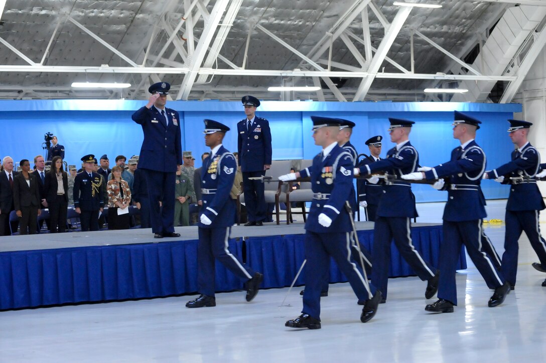 JOINT BASE ANDREWS, Md. -- Colonel Ken Rizer, 11th Wing/Joint Base Andrews commander, salutes as the U.S. Air Force Ceremonial Honor Guard pass in review as Maj. Gen. Darrell Jones, Air Force District of Washington commander, observes during the 11 WG Mission Movement ceremony Oct. 1 in Hangar 3 here. (U.S. Air Force photo by Bobby Jones) 