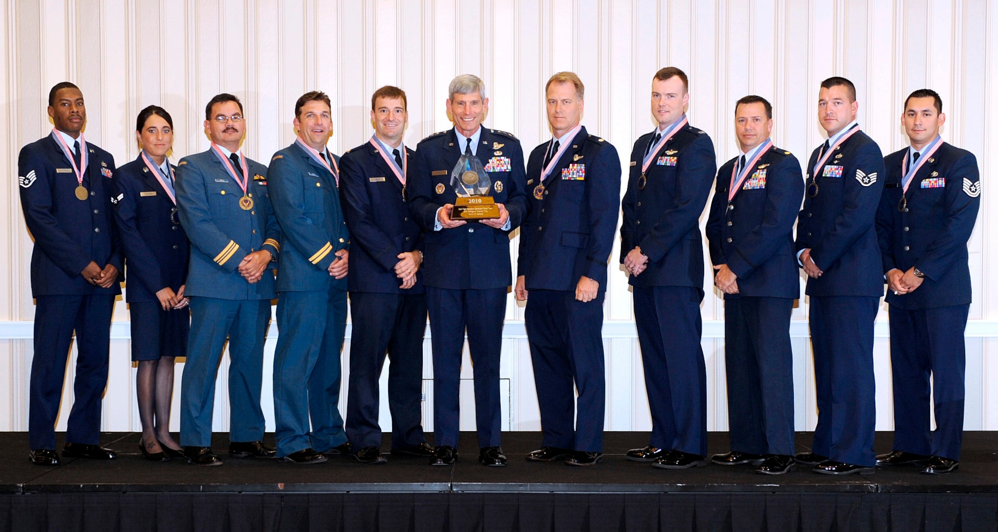 (From left to right) Staff Sgt. Dennis Patterson, Airman 1st Class Andrea Schams, Maj. James Fell (Canadian Air Force), Capt. Richard Gough (Canadian Air Force), Maj. David Smith, Air Force Chief of Staff Gen. Norton Schwartz, Lt. Col. Bradley Graff, Capt. Justin Longmire, Maj. J.J. Grindrod, SSgt. Aaron White and Tech Sgt. Alex Calderon from the  615th Contingency Response Wing's Haiti Flight Operations Coordination Center Team at Travis Air Force Base, Calif., receive their AF CSAF Team Excellence Award. (Courtesy photo)