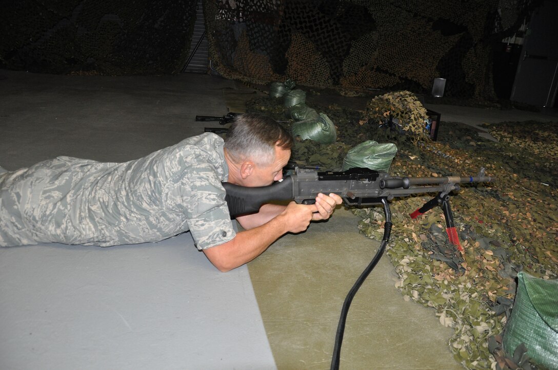 WRIGHT-PATTERSON AIR FORCE BASE, Ohio – Maj. Gen.  Eric Crabtree, 4th Air Force commander, fires during a scenario on the Fire Arms Training Simulator using the M-240 as part of his visit to the 445th Airlift Wing Sept. 28. General Crabtree toured various 445th AW areas during his two-day visit to the base.  (U.S. Air Force photo/Staff Sgt. Robert Nelson)