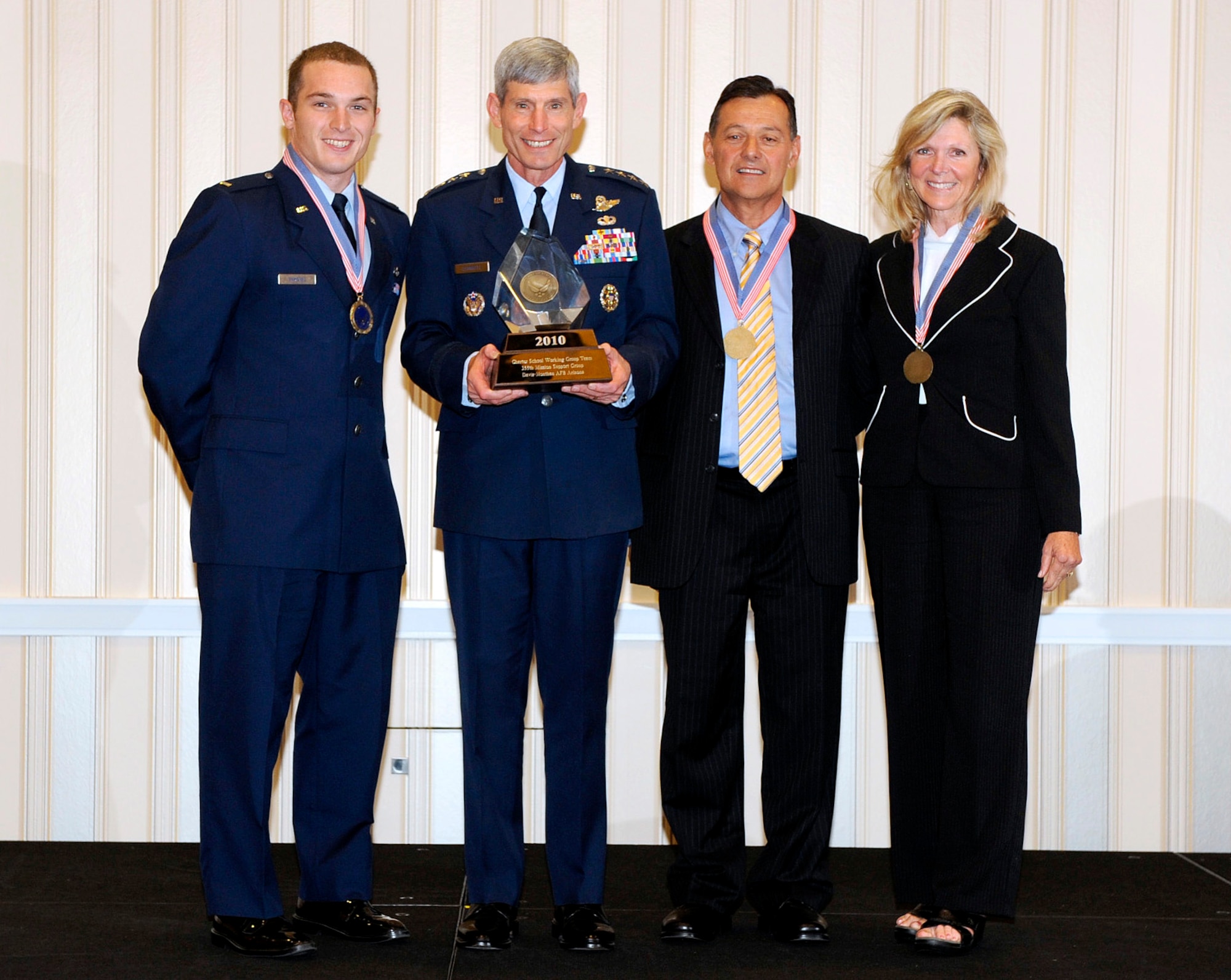 (From left to right) Second Lieutenant Thomas Synovec Air Force Chief of Staff Gen. Norton Schwartz, Mr. Michael Toriello, and Jane Toriello from the 
355th Mission Support Group Charter School Working Group Team at Davis-Monthan AFB, Ariz., receive their AF CSAF Team Excellence Award. (Courtesy photo)