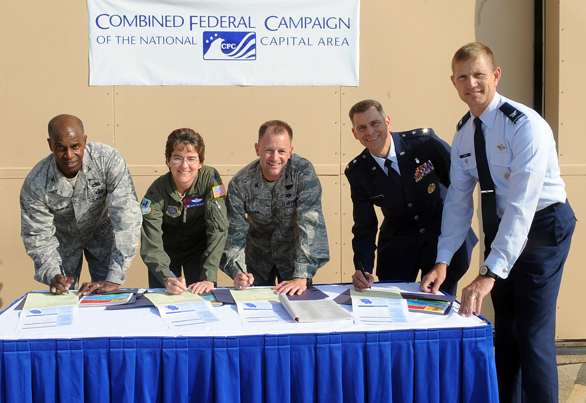 JOINT BASE ANDREWS, Md. -- Air Force leadership recognizes the beginning of the Combined Federal Campaign by completing their donation forms before the 79th Medical Wing change of command ceremony on Joint Base Andrews Sept. 24. The Air Force CFC start date is Oct. 4 and those wishing to donate may contact your unit's CFC key worker. (U.S. Air Force photo by Senior Airman Melissa Brownstein)