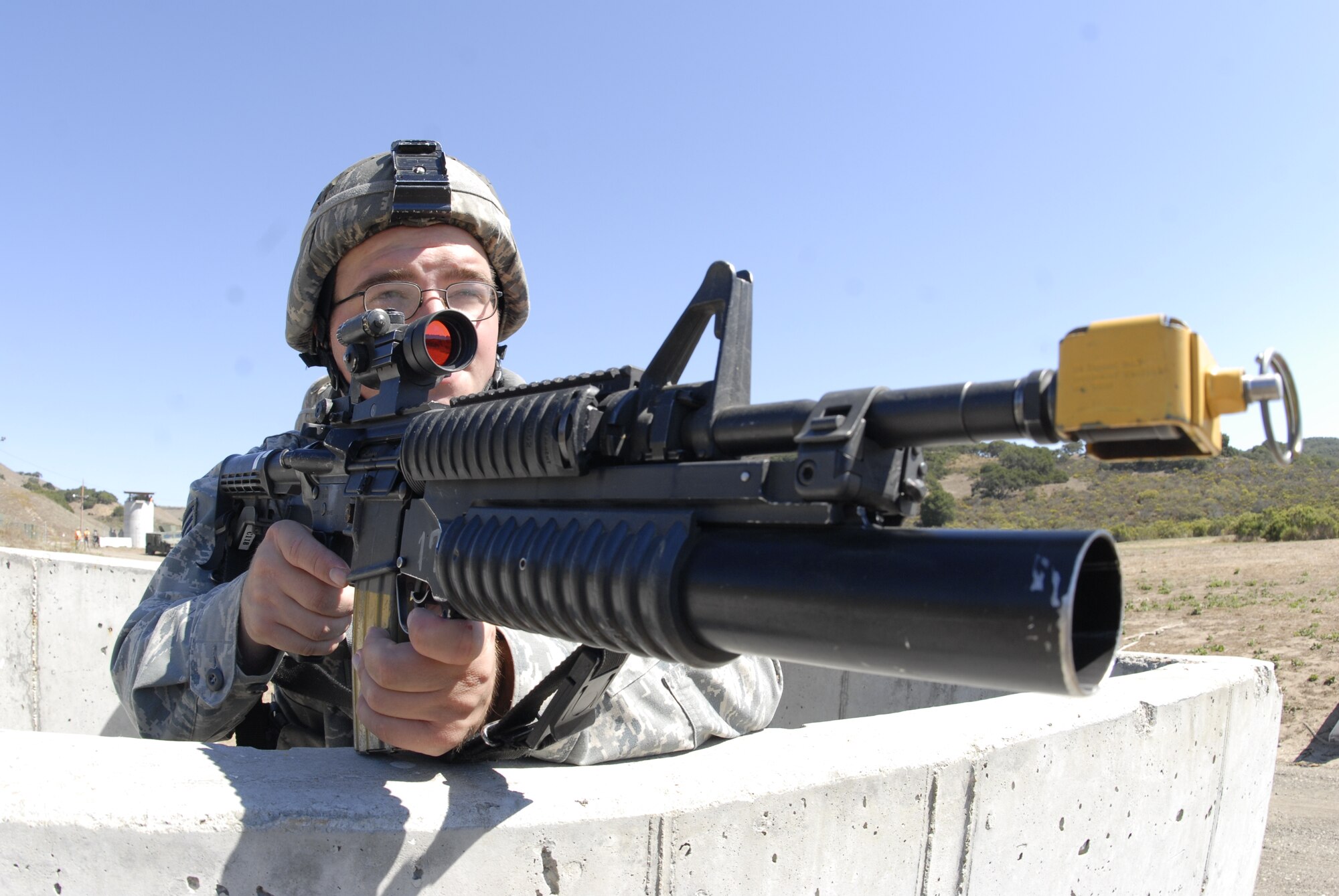 VANDENBERG AIR FORCE BASE, Calif. -- Checking for opposition forces, Senior Airman Zachrey Shuey, a 30th Security Forces Squadron member, aims his M203 rifle to protect his area during the Northstar exercise here Thursday, Sept. 23, 2010.  Northstar is an exercise that helps train and test Airmens' abilities in a simulated deployed environment.  (U.S. Air Force photo/Senior Airman Andrew Satran) 

 
 

 