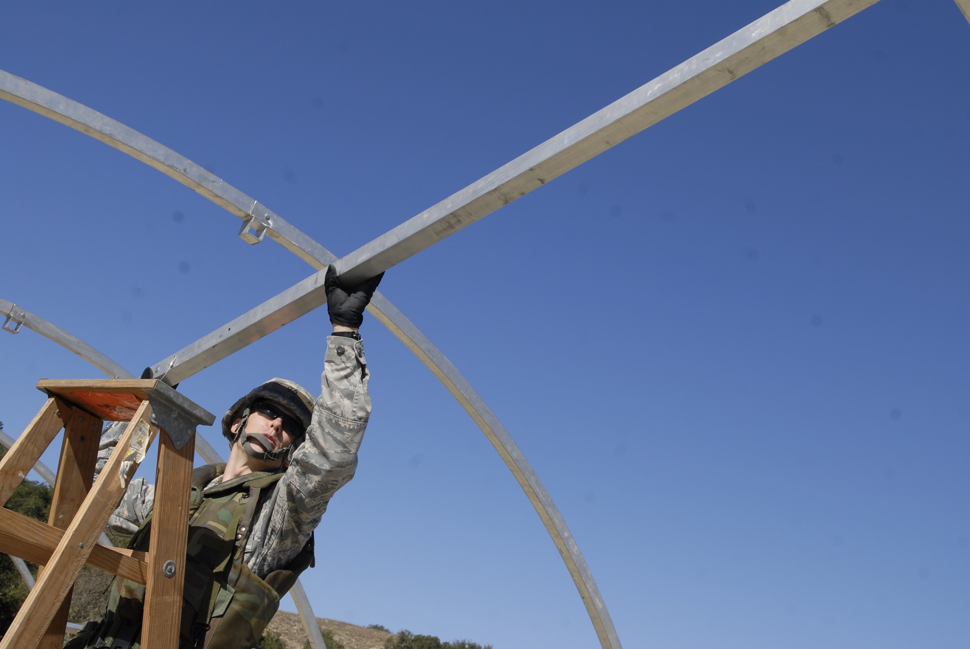 VANDENBERG AIR FORCE BASE, Calif. -- Setting up a medical tent, Airman 1st Class Michael Necessary, 30th Medical Operations Support Squadron member, puts the last brace in the tent during the Northstar exercise here Thursday, Sept. 23, 2010.  Team V members practiced skills that they will use in a deployed environment.  (U.S. Air Force photo/Senior Airman Andrew Satran) 

 