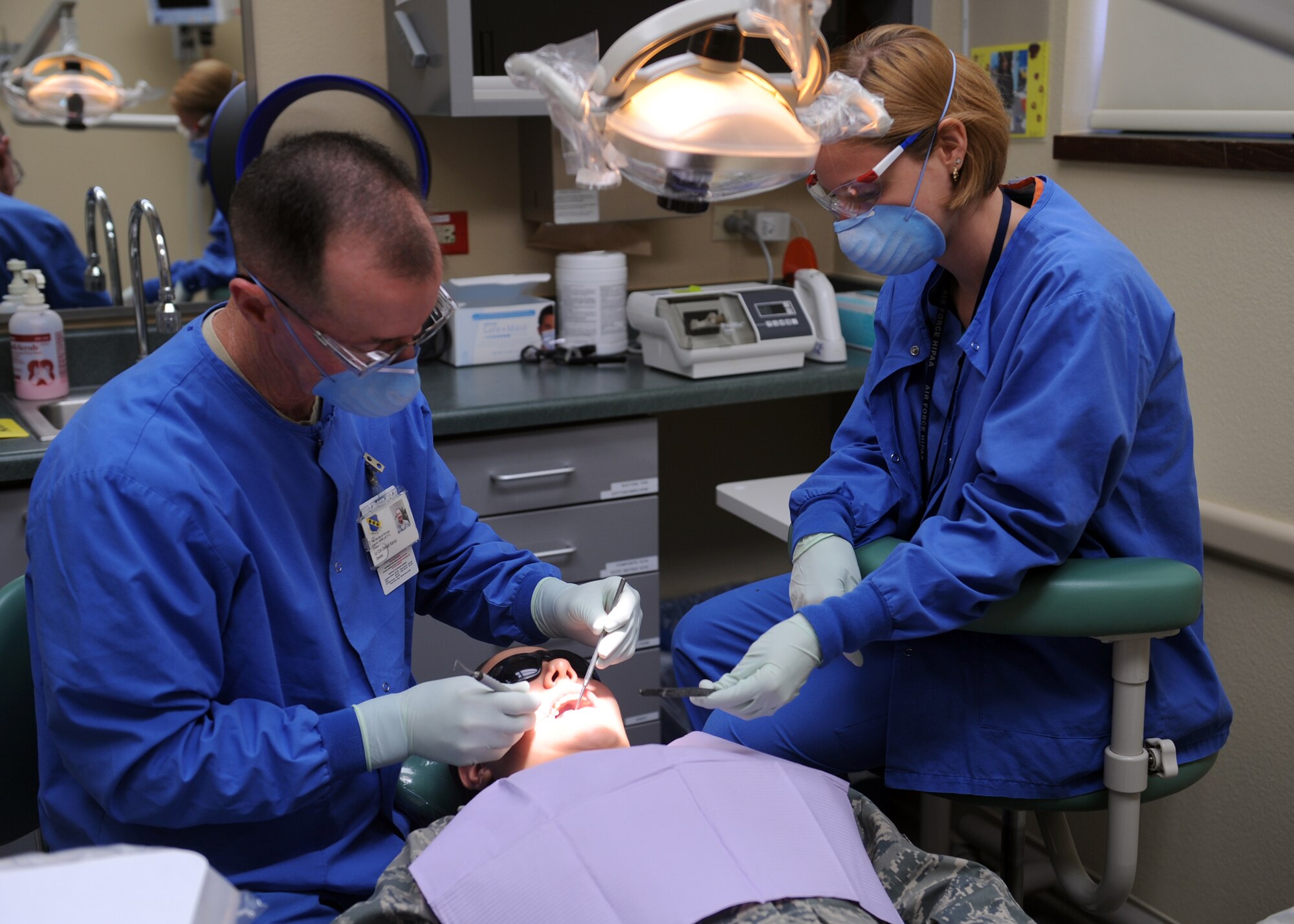 DYESS AIR FORCE BASE, Texas-- Lt. Col. David Kemp, 7th Aerospace Medical Dental Squadron dentist, and Crystal Rodriguez, 7AMDS dental assistant, perform a check-up on Airman 1st Class Alyssa De La Rosa, 7AMDS dental technician, at the dental clinic here Sept. 28. The dental clinic is open Monday through Friday from 7:30 a.m. to 4:30 p.m. Dental sick call is daily at 1 p.m. on a first-come, first-serve basis. The clinic is closed the second Friday of every month for required military readiness training. All patients must present a valid military, dependent or retiree ID card upon check-in at the records and reception area. For more information, call (325) 696-2304. (U.S. Air Force photo/ Senior Airman Felicia Juenke)