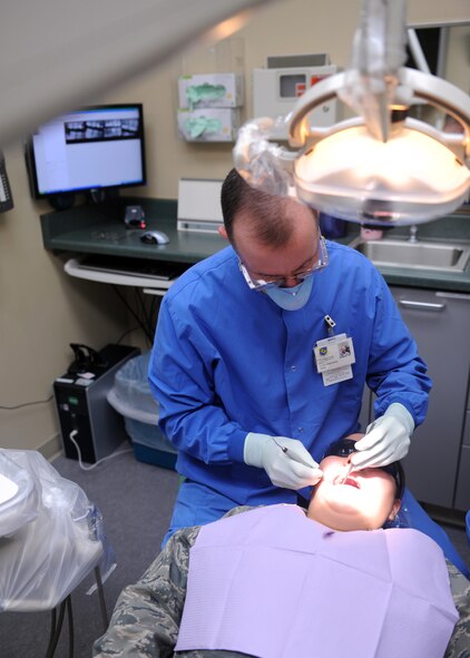 DYESS AIR FORCE BASE, Texas--Lt. Col. David Kemp, 7th Aerospace Medical Dental Squadron dentist, performs a check-up on Airman 1st Class Alyssa De La Rosa, 7AMDS dental technician, at the dental clinic here Sept. 28. The dental clinic is open Monday through Friday from 7:30 a.m. to 4:30 p.m. Dental sick call is daily at 1 p.m. on a first-come, first-serve basis. The clinic is closed the second Friday of every month for required military readiness training. All patients must present a valid military, dependent or retiree ID card upon check-in at the records and reception area. For more information, call (325) 696-2304. (U.S. Air Force photo/ Senior Airman Felicia Juenke)