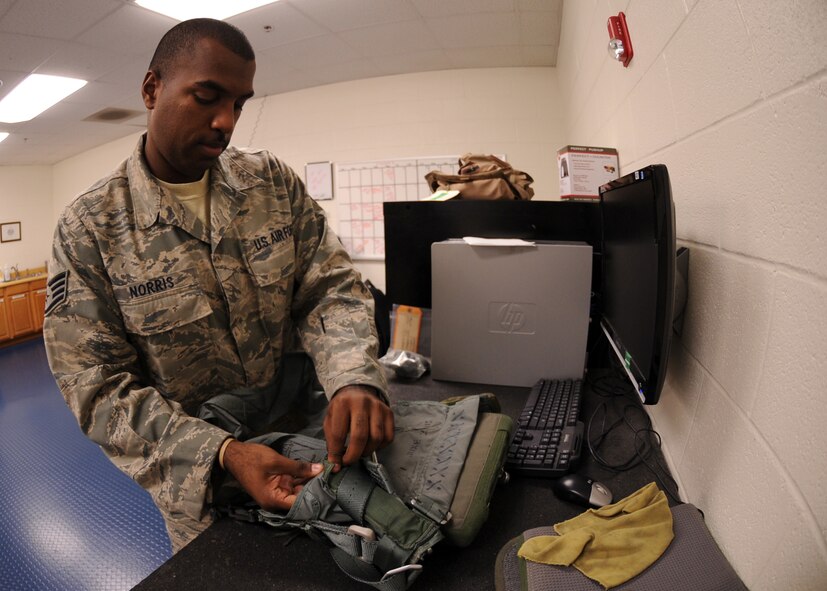 DYESS AIR FORCE BASE, Texas-- Staff Sgt. Raymond Norris, 7th Operations Support Squadron aircrew flight equipment craftsman, inspects life support equipment Sept. 28 here. Inspections are performed to ensure there are no holes or cracks in the equipment and it is serviceable. (U.S. Air Force photo/ Senior Airman Felicia Juenke)