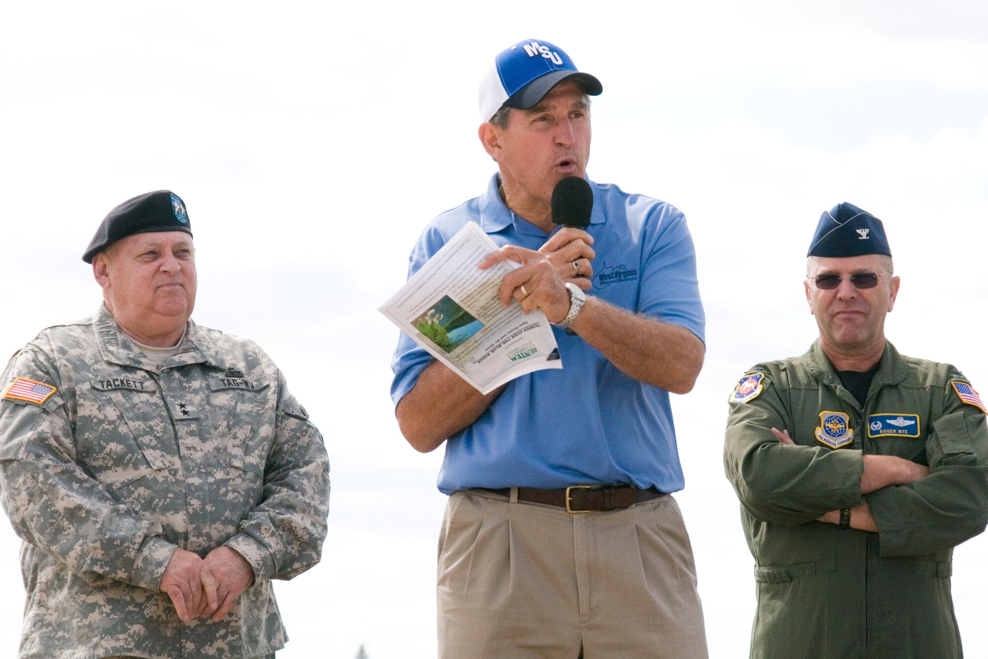 West Virginia Adjutant General, Major General Alan Tackett and 167th Airlift Wing commander, Colonel Roger Nye stand behind West Virginia Governor, Joe Manchin III, as he speaks during the opening ceremonies of the Thunder Over the Blue Ridge Open House and Air Show. The 167th Airlift Wing, West Virginia Air National Guard unit in Martinsburg, WV held an open house in conjuction with the Thunder Over the Blue Ridge Air Show on September 4 and 5, 2010. The U.S. Air Force Thunderbirds and the U.S. Army Golden Knights headlined the show. (U.S. Air Force photo by MSgt Emily Beightol-Deyerle)