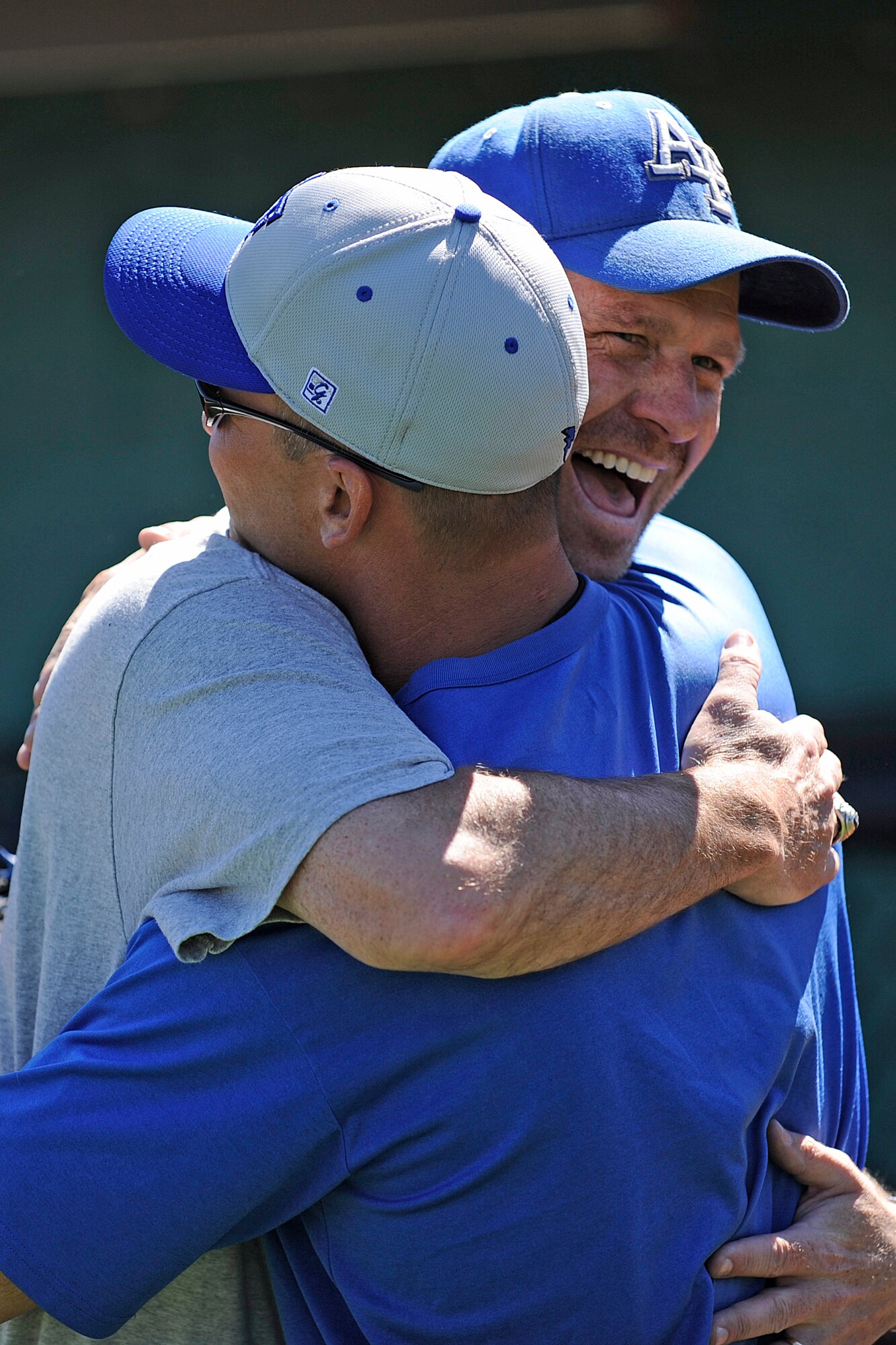 Air Force baseball head coach Michael Kazlausky, facing camera, hugs Troy Simon, an all-american catcher who graduated from the Air Force Academy in 1992, during an Air Force baseball reunion at the Academy Sept. 24, 2010. More than 50 alumni attended the three day reunion Sept. 24-26. (U.S. Air Force photo/Mike Kaplan)