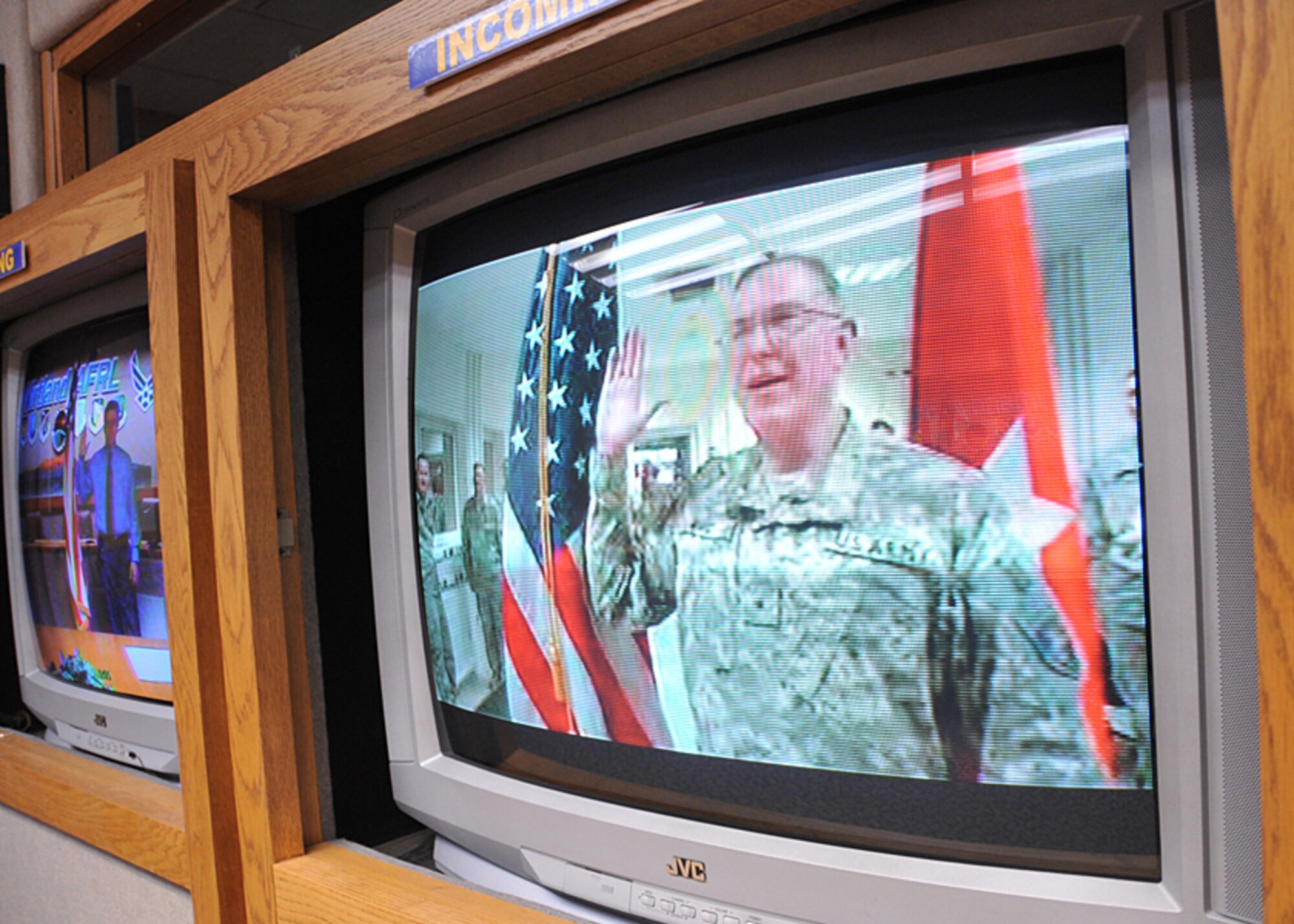 Retired Brigadier General Roger Ward, in Afghanistan, commissions his son, Greg Ward, into the Army via video teleconference Sept. 22 at the Air Force Research Laboratory VTC room.  U.S. Air Force Photo by Todd Berenger. 