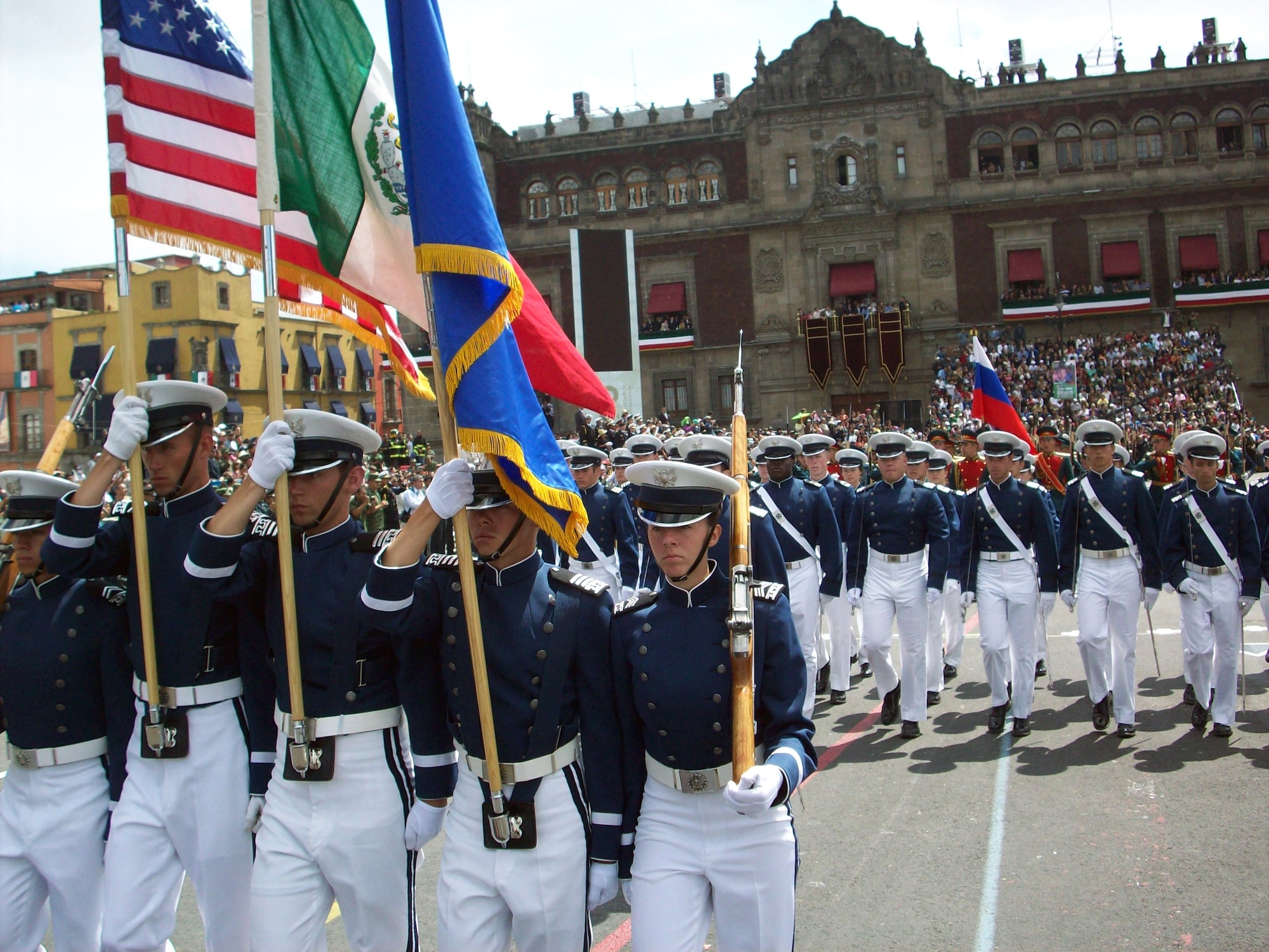 Left to right: Cadets 2nd Class Chris Ganczewski and Justin Harris, Cadets 1st Class Josh Stroud and Bryan Altman and Cadet 2nd Class Kathryn Stuard carry the American, Mexican and Air Force flags during a march in Mexico City's Plaza de la Constitución during Mexico's bicentennial celebration Sept. 16. Marching behind the honor guard are members of Cadet Squadron 19. (U.S. Air Force photo/Capt. Randy Sharpe)