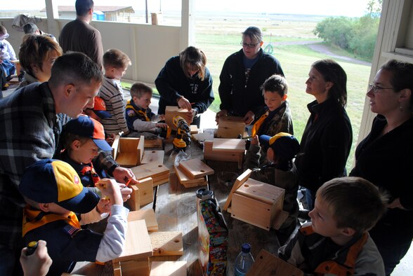 Members of Cub Scout Pack 43 and their parents work together to build bird houses to place around the pond and different areas throughout the installation for their National Public Lands Day Project Sept. 25. (U.S. Air Force photo/Airman 1st Class Kristina Overton)