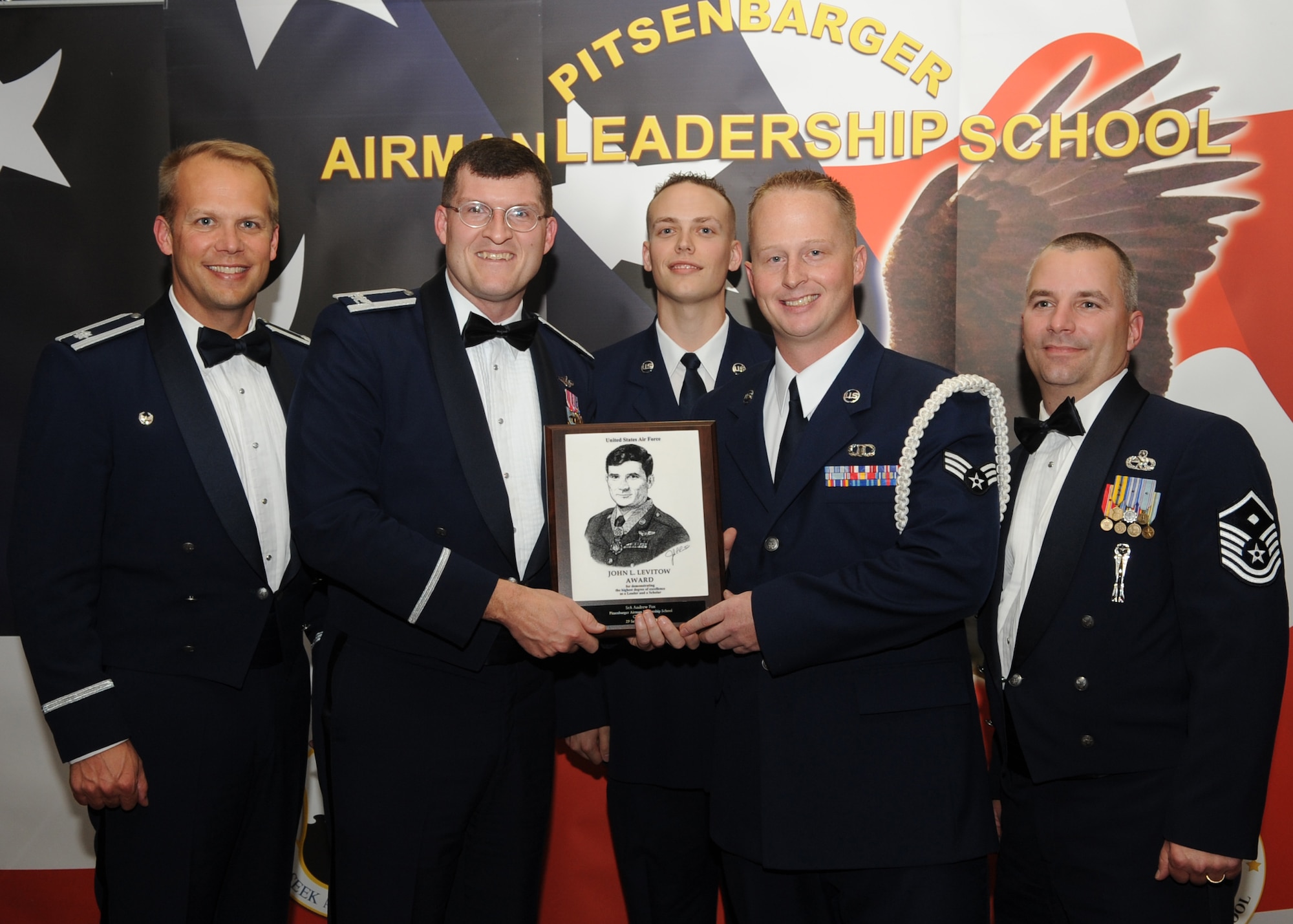 SPANGDAHLEM AIR BASE, Germany --  Senior Airman Andrew Fox, 52nd Operations Support Squadron air traffic controller, accepts the John L. Levitow Award from Col. Clinton Hinote, 52nd Fighter Wing vice commander, during the Pitsenbarger Airman Leadership School Class 10-8 graduation in Club Eifel Sept. 28. The John L. Levitow award is the highest level award an Airman can receive upon completion of ALS. (U.S. Air Force photo/Senior Airman Nick Wilson) 