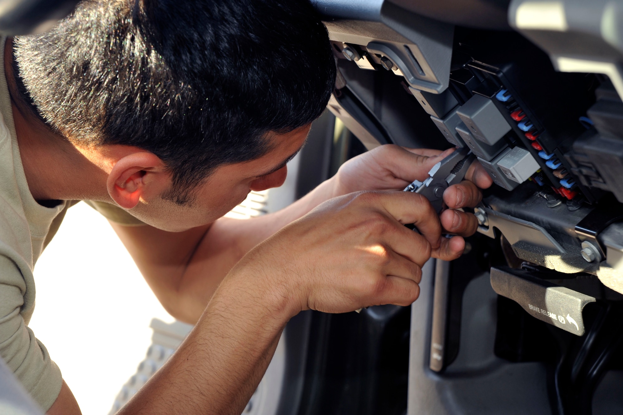 U.S. Air Force Senior Airman Nathaniel Embry, 35th Logistics Readiness Squadron Vehicle Maintenance Flight, replaces a light fuse on one of the fleet?s trucks at Misawa Air Base, Japan, Sept. 30, 2010. Airman Embry is part of the customer service area of the flight, where vehicle maintenance and repair jobs that can be completed in two hours or less are conducted. (U.S. Air Force photo by Tech. Sgt. Russell McBride/Released)