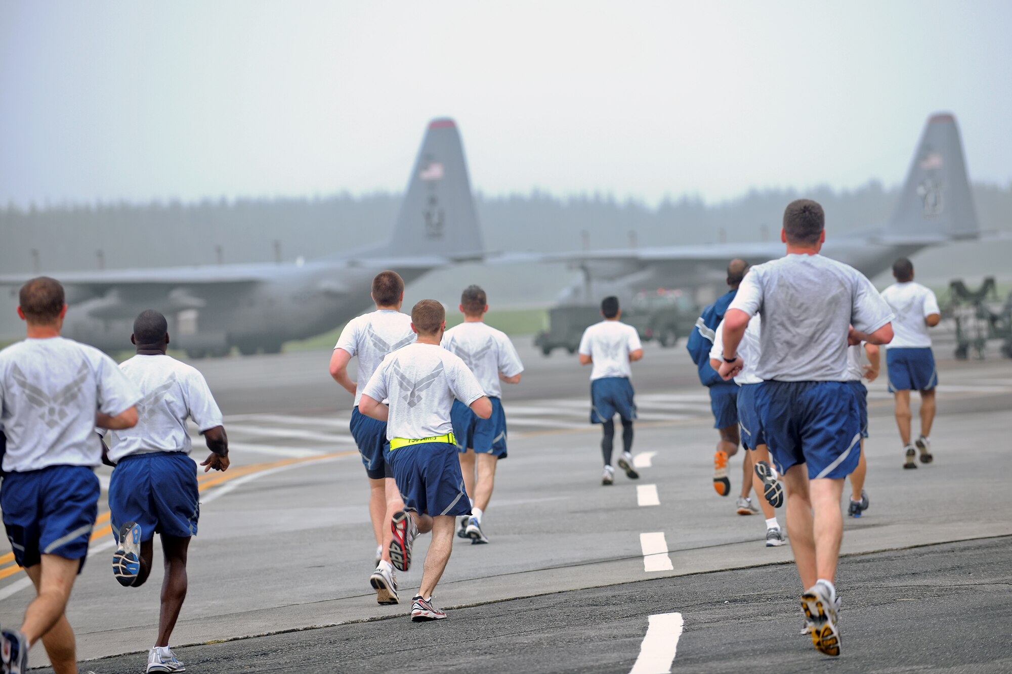 YOKOTA AIR BASE, Japan -- Yokota Airmen run on the flightline here Oct. 1 during the weekly wing run. The Combined Federal Campaign - Overseas (CFC-O) kicks off here today. CFC-O, the annual giving drive for the Department of Defense, announced a $15.7 million campaign goal. During the campaign season, uniformed and civilian personnel can contribute to help people in need, across the nation and around the world. The Yokota CFC-O goal is $300.000. (U.S. Air Force photo/Osakabe Yasuo)