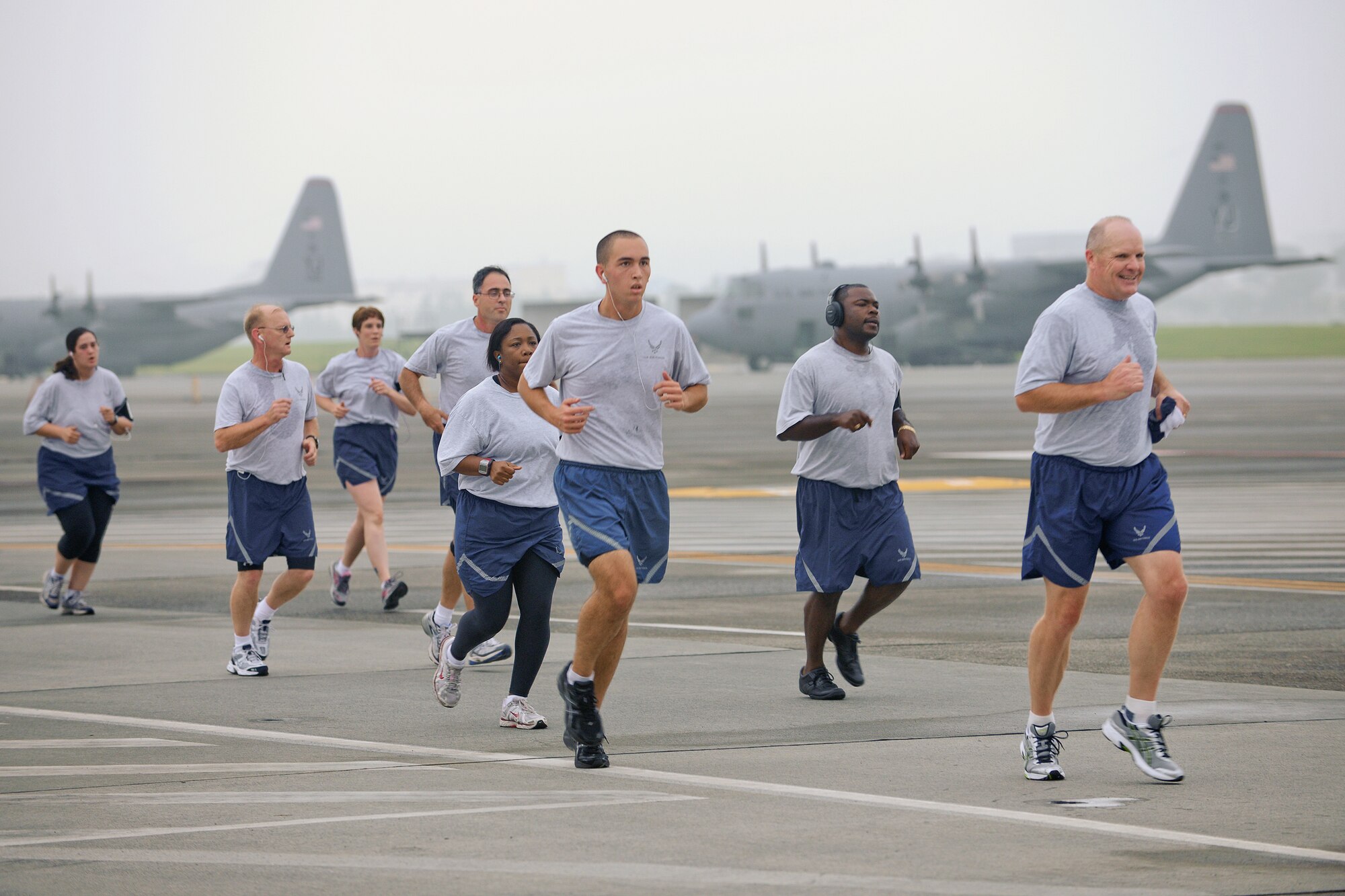 YOKOTA AIR BASE, Japan -- Yokota Airmen run on the flightline here Oct. 1 during the weekly wing run. The Combined Federal Campaign - Overseas (CFC-O) kicks off here today. CFC-O, the annual giving drive for the Department of Defense, announced a $15.7 million campaign goal. During the campaign season, uniformed and civilian personnel can contribute to help people in need, across the nation and around the world. The Yokota CFC-O goal is $300.000. (U.S. Air Force photo/Osakabe Yasuo)