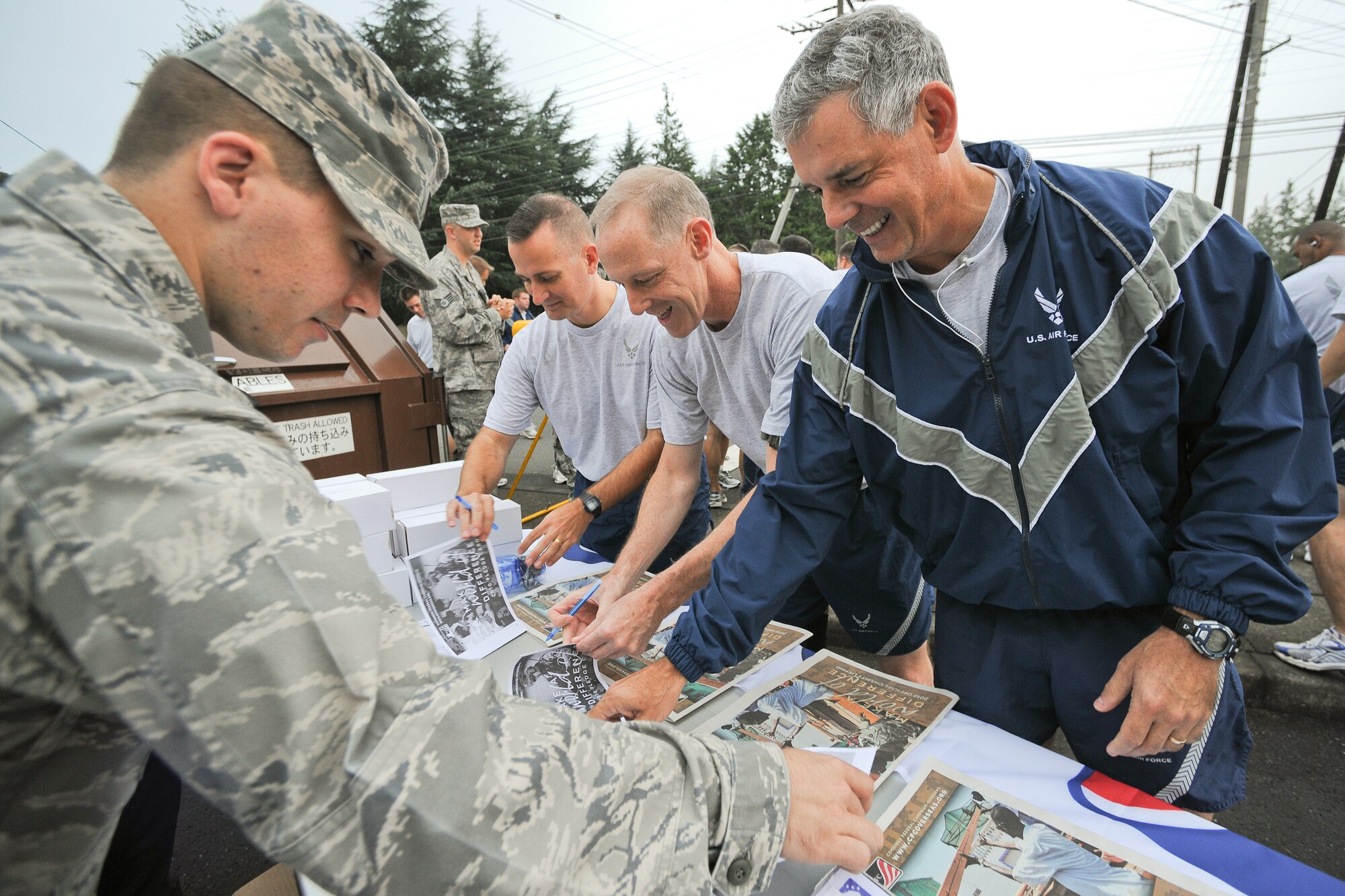 YOKOTA AIR BASE, Japan -- Maj. Gen. Salvatore Angelella (right), Fifth Air Force vice commander, visits the CFC-O booth here Oct. 1 during the weekly Wing Run. The Combined Federal Campaign-Overseas is the only authorized solicitation of employees in the federal workplace on behalf of a variety of charitable organizations. The Yokota CFC-O goal for 2010 is $300.000.00. (U.S. Air Force photo/Osakabe Yasuo)