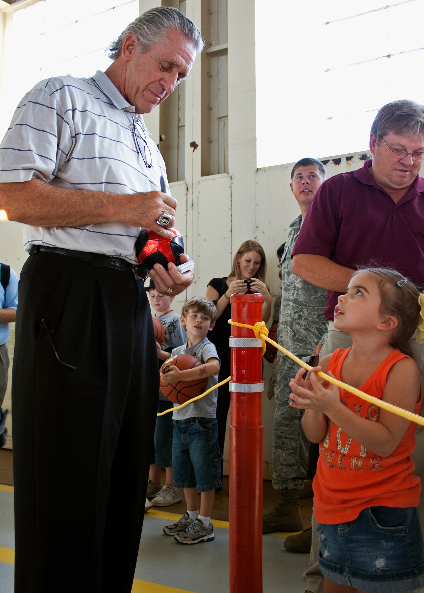 Miami Heat team president Pat Riley signs an autograph for a young fan during the team’s tour of the 46th Test Wing’s facility at Eglin Air Force Base, Fla., Sept. 30.  The team was in the area for a training camp at Hurlburt Field.   Other members of the team visited Eglin’s ground combat training squadron and the youth center.  (U.S. Air Force photo/2nd Lt. Andrew Caulk)