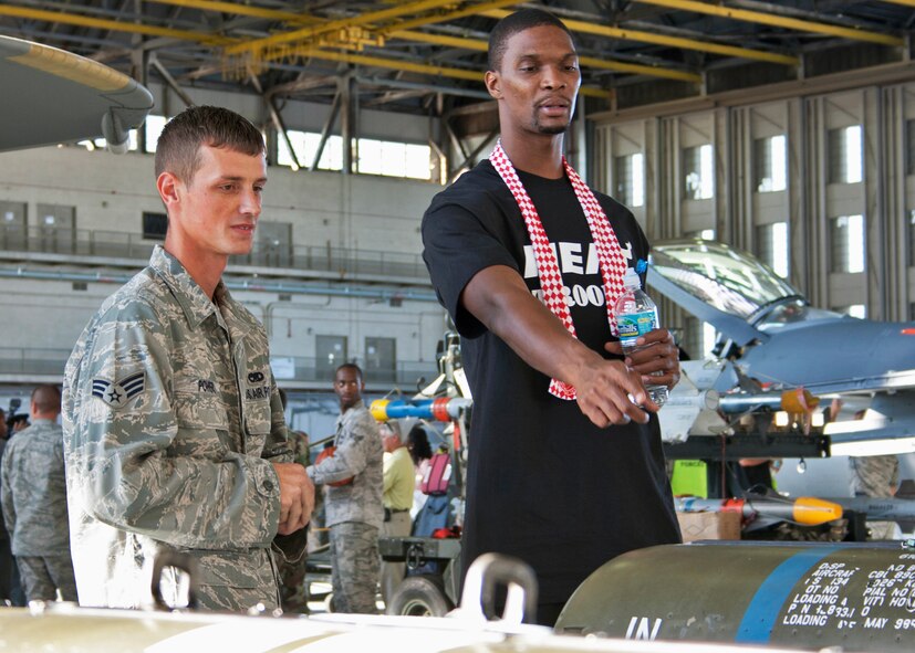 Miami Heat’s Chris Bosh talks over bombs with Senior Airman Nathaniel Powers, 46th Maintenance Group, during the team’s tour of the 46th Test Wing’s facility at Eglin Air Force Base, Fla., Sept. 30.  The team was in the area for a training camp at Hurlburt Field.   Other members of the team visited Eglin’s ground combat training squadron and the youth center.  (U.S. Air Force photo/2nd Lt. Andrew Caulk)