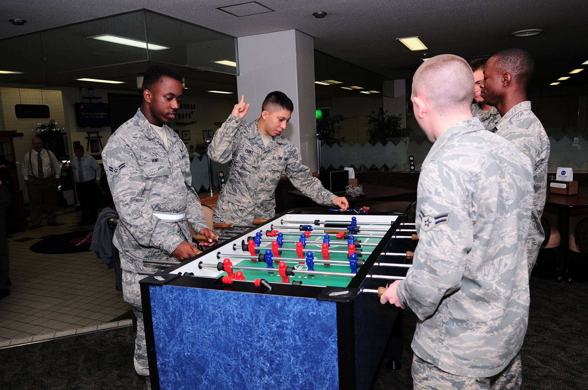 YOKOTA AIR BASE, Japan - A group of Airmen face off in a game of foosball at the Samurai Cafe Sept. 30, during the monthly customer appreciation meal. During the meal Airmen could eat great food and then stay to play in the foosball tournament, or participate in Ping pong, Xbox games, Mini basketball pop shot and Wii games. (U.S. Air Force photo/Staff Sgt. Stacy Moless)
