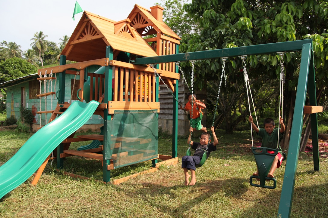 Panamanian children swing on the swing set of a playground, Oct. 2, 2010, which was built by Continuing Promise Marines and sailors at an engineer site in Silico Creek, Panama. Marines and sailors of CP10 are anchored off the coast of Chiriqui Grande, Panama, to conduct humanitarian operations. CP10 is a humanitarian civic assistance mission that provides medical, dental, veterinary, engineering support and disaster relief efforts to the Caribbean, Central and South America.