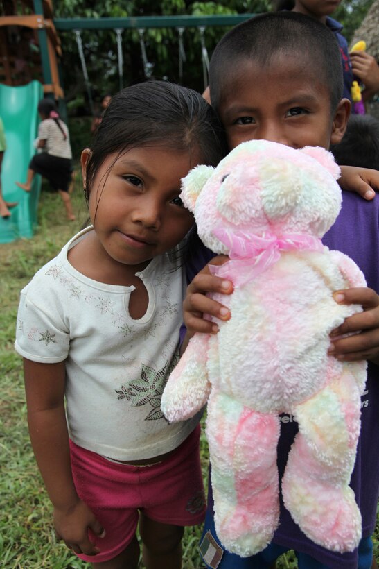 Panamanian children hold a stuffed animal given by non-government organization Give a Kid a Backpack at an engineer site in Silico Creek, Panama, Oct. 2, 2010. Marines and sailors of CP10 are anchored off the coast of Chiriqui Grande, Panama, to conduct humanitarian operations. CP10 is a humanitarian civic assistance mission that provides medical, dental, veterinary, engineering support and disaster relief efforts to the Caribbean, Central and South America.