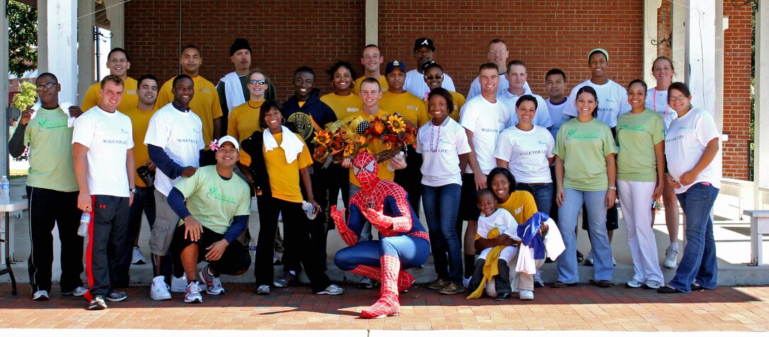 Marines and sailors with 2nd Marine Logistics Group take time at the end of a charity walk to pose for a group photo in Jacksonvill, N.C., Oct. 2, 2010.  The service members not only participated in the walk, they also raised money as a team and volunteered during the event.  (U.S. Marine Corps photo by Lance Cpl. Katherine M. Solano)