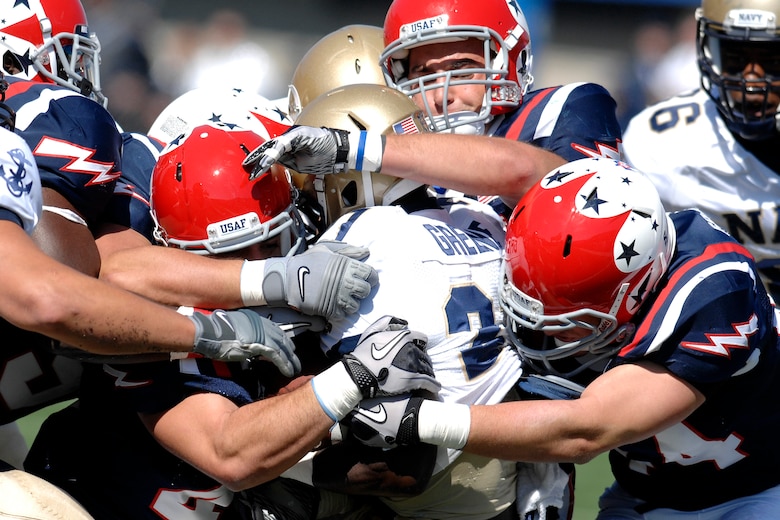 The Air Force Academy Falcon defense swarms the Navy ball carrier on the field at Falcon Stadium as Air Force defeated Navy 14-6 at the U.S. Air Force Academy's Falcon Stadium in Colorado Springs, Colo., Oct. 2, 2010. This was the Falcons' first victory over Navy since 2002. (U.S. Air Force photo/Mike Kaplan)   