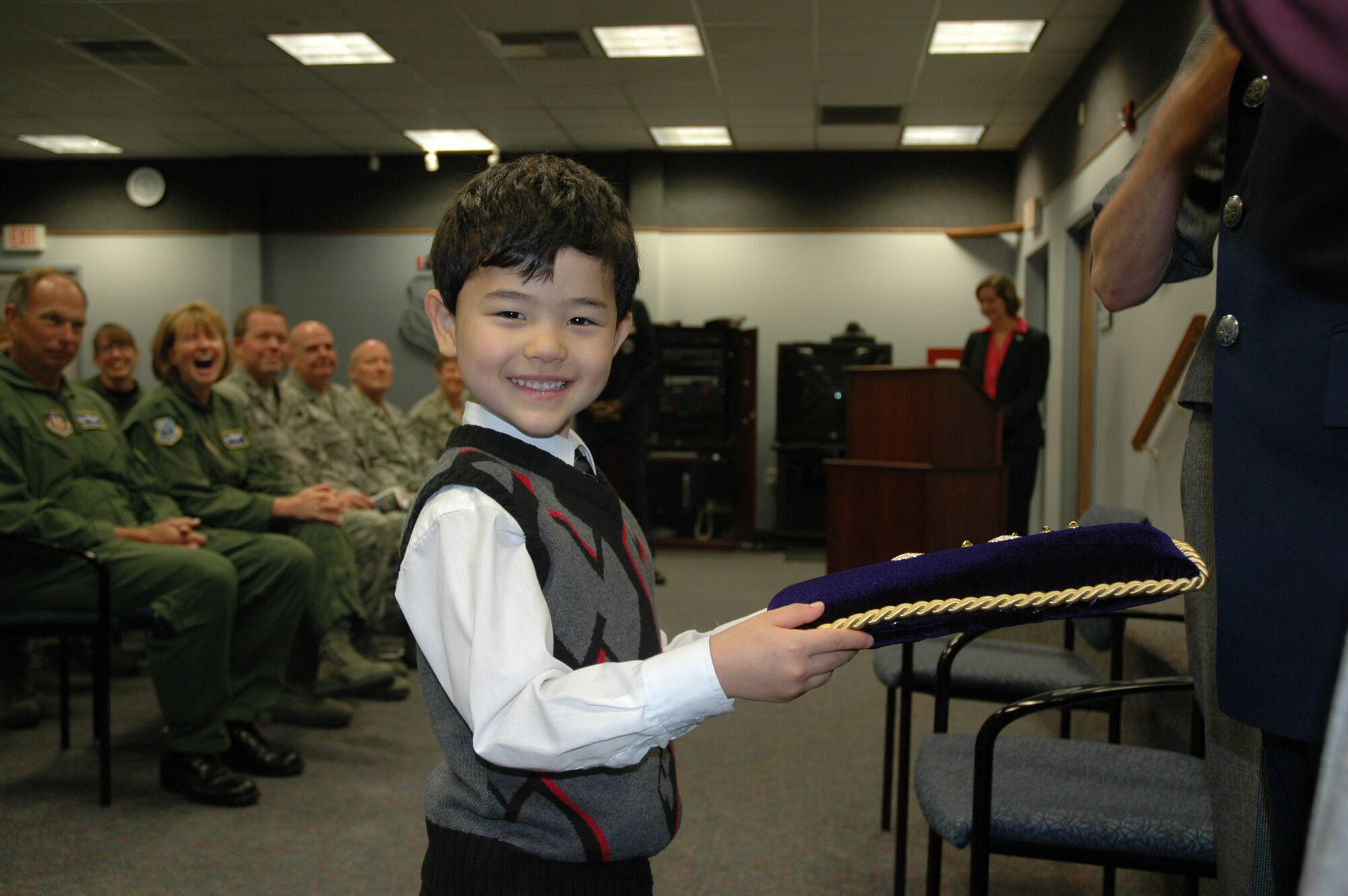 JOINT BASE LEWIS-MCCHORD, Wash. -- Alexander Lee, son of Lt. Col. Steven Lee, wing executive for the 446th Airlift Wing, holds the pillow as the propher for his father's promotion ceremony here Oct 1, 2010.   (USAF photo/2nd Lt Denise Hauser)